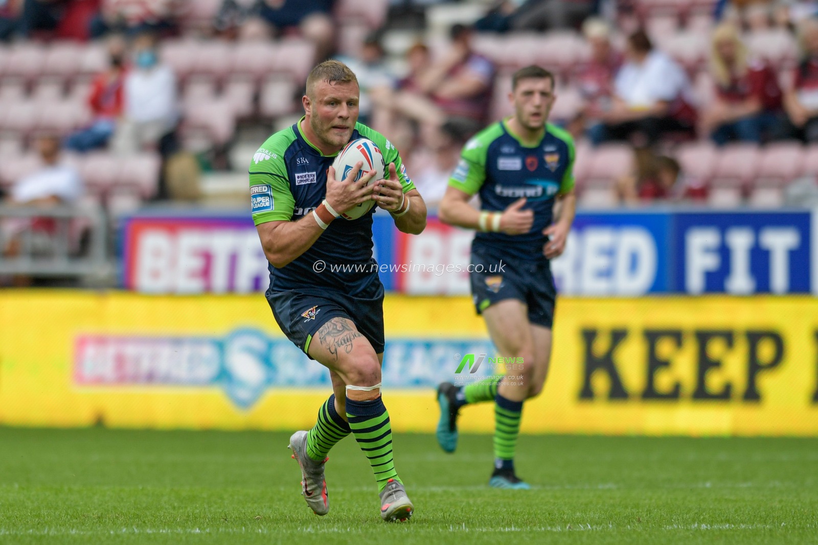 Josh Jones (13) of Huddersfield Giants runs with the ball