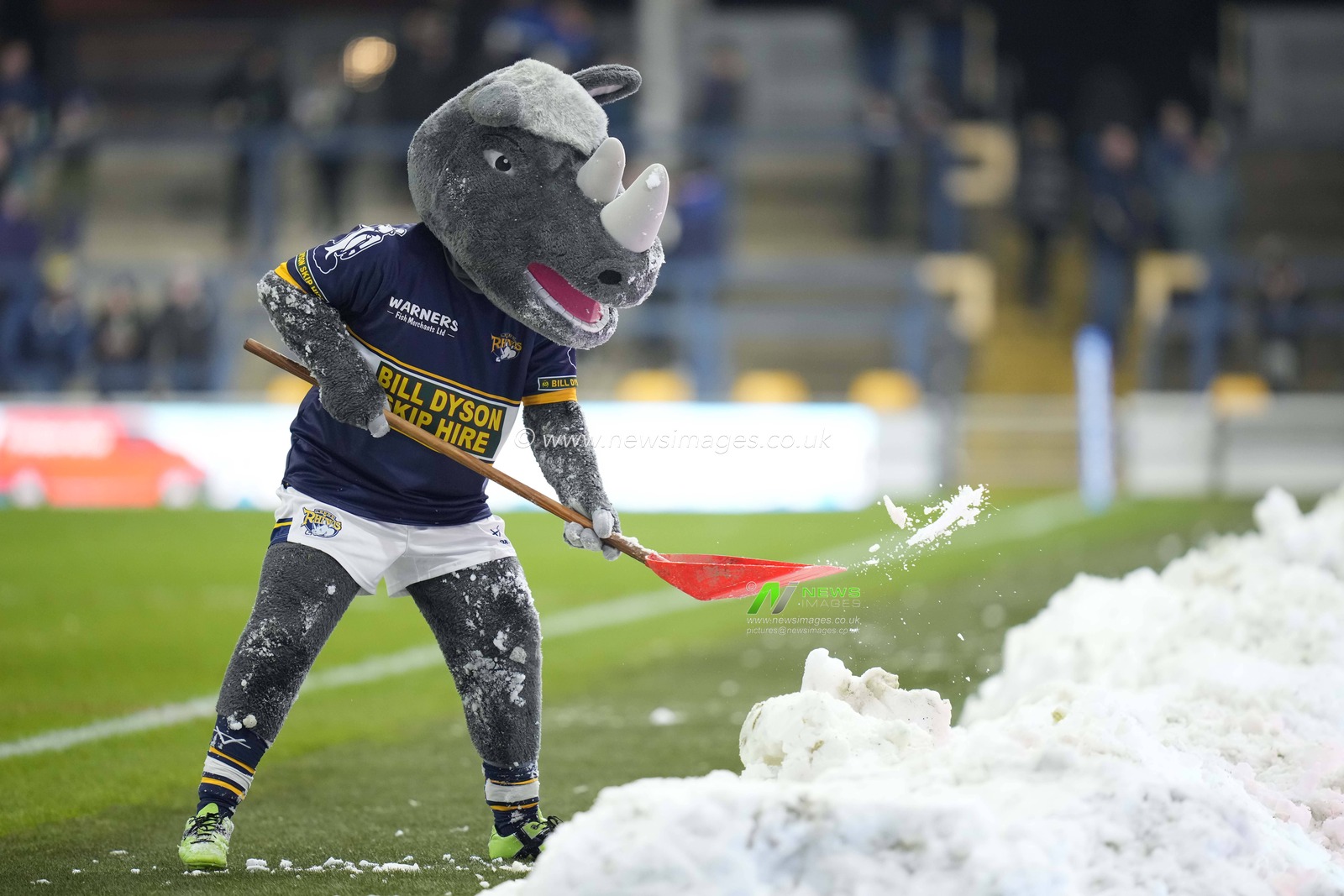 Leeds Rhinos mascot Ronnie Rhino clears snow from the side of the pitch before the Betfred Super League Round 4 match Leeds Rhinos vs Wakefield Trinity at Headingley Stadium, Leeds, United Kingdom, 10th March 2023

(Photo by Steve Flynn/News Images)