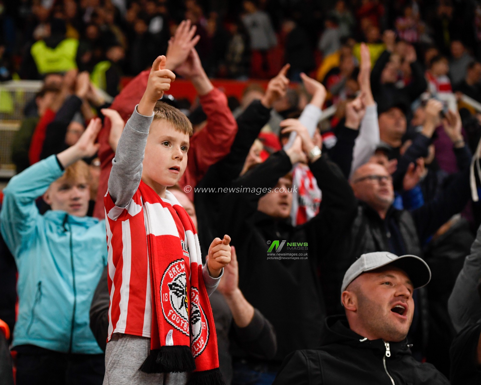 A young Brentford fan celebrates his side progressing to the next round of the Carabao Cup after his side beat Stoke City 1-2