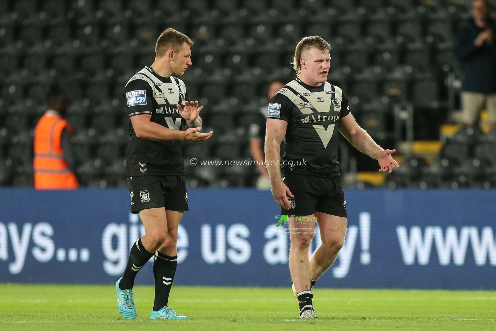 Dejected Hull FC players walk around the pitch after the final whistle to an almost empty East stand