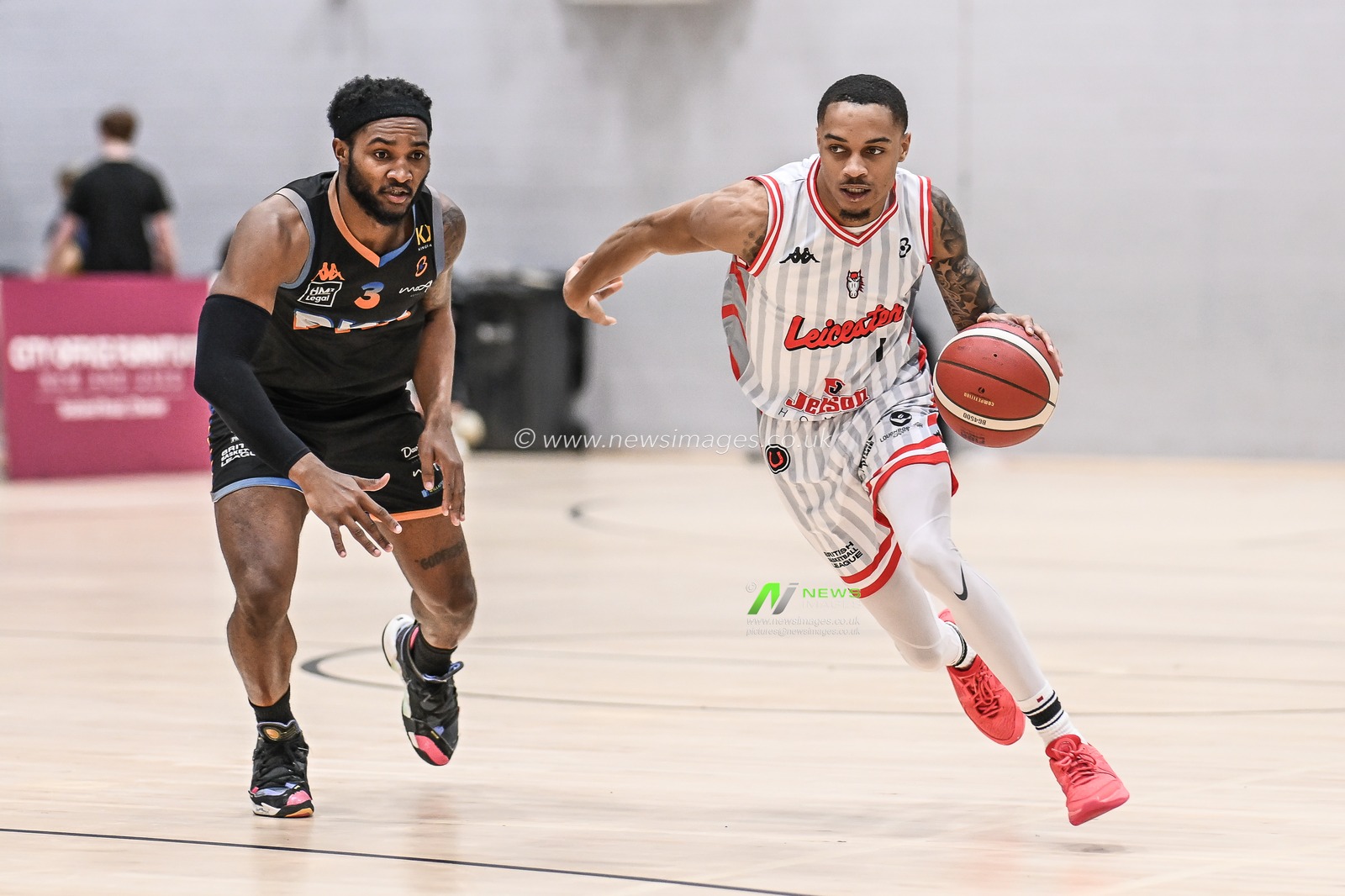 Xavier Pinson of Leicester Riders drives past LaQuincy Rideau of Cheshire Phoenix during the British Basketball Championship match Cheshire Phoenix vs Leicester Riders at Ellesmere Port Sports Village, Ellesmere Port, United Kingdom, 12th November 2023

(Photo by Craig Thomas/News Images)