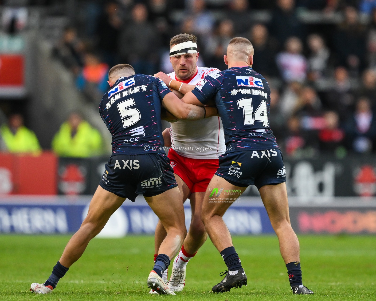 Matty Lees of St. Helens is tackled by Jarrod Oâ€™Connor of Leeds Rhinos and Ash Handley of Leeds Rhinos during the Betfred Super League Round 12 match St Helens vs Leeds Rhinos at Totally Wicked Stadium, St Helens, United Kingdom, 24th May 2024

(Photo by Craig Thomas/News Images)