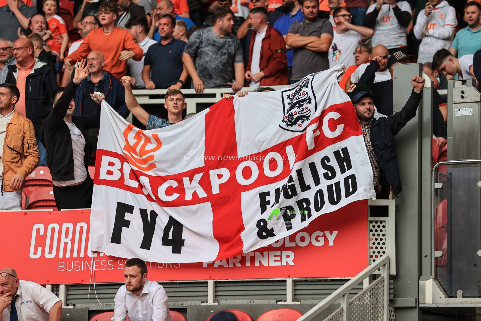 Blackpool fans hold up a huge flag as Blackpool head out to win 1-2
