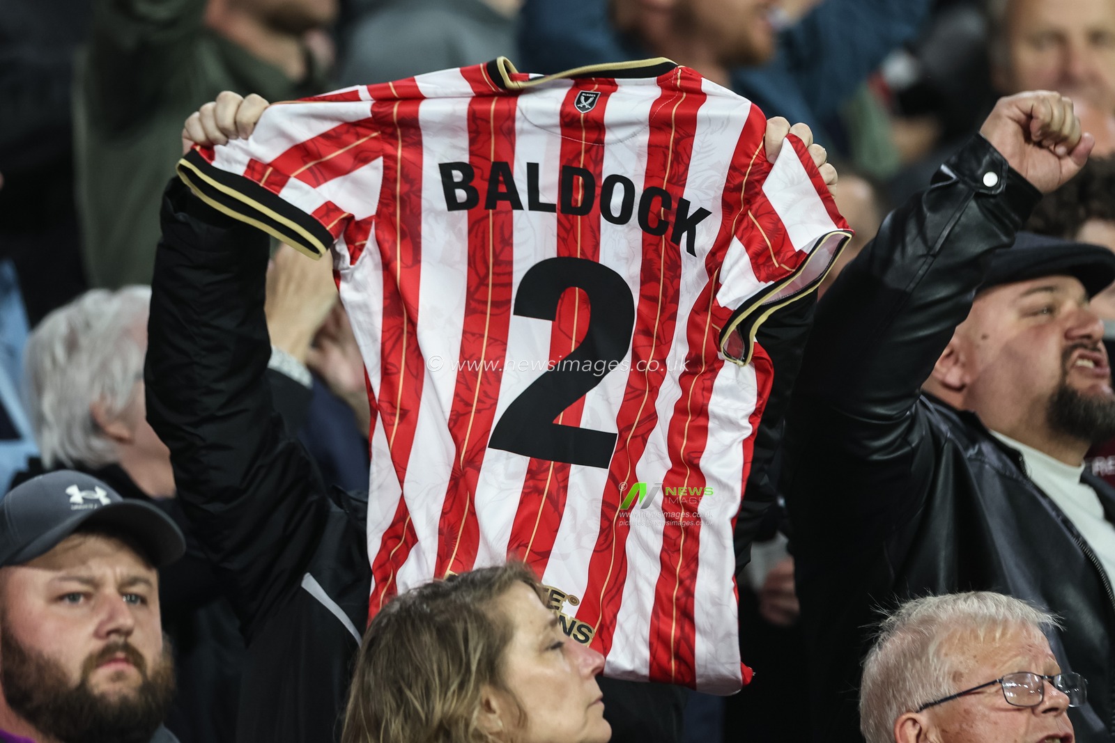 A Sheffield United fan holds up a George Baldock shirt after his passing this week during the Sky Bet Championship match Leeds United vs Sheffield United at Elland Road, Leeds, United Kingdom, 18th October 2024

(Photo by Mark Cosgrove/News Images)