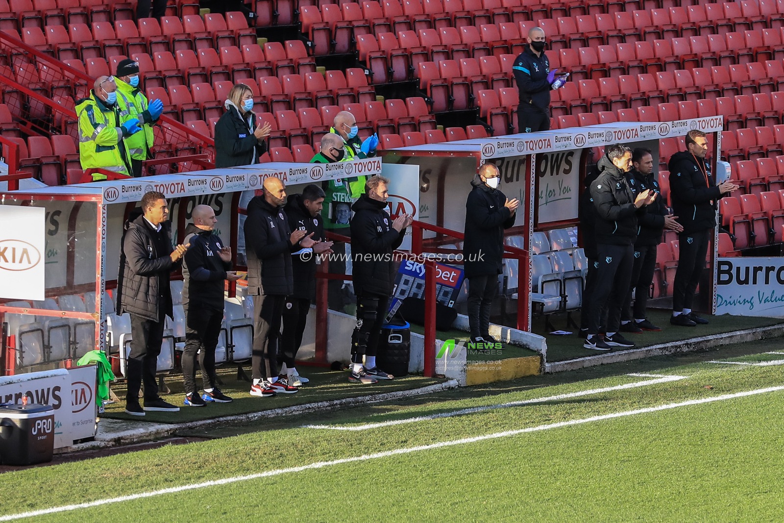 Barnsley and Watford staff hold a minutes applause as a mark of respect for the recent passing of Nobby Stiles