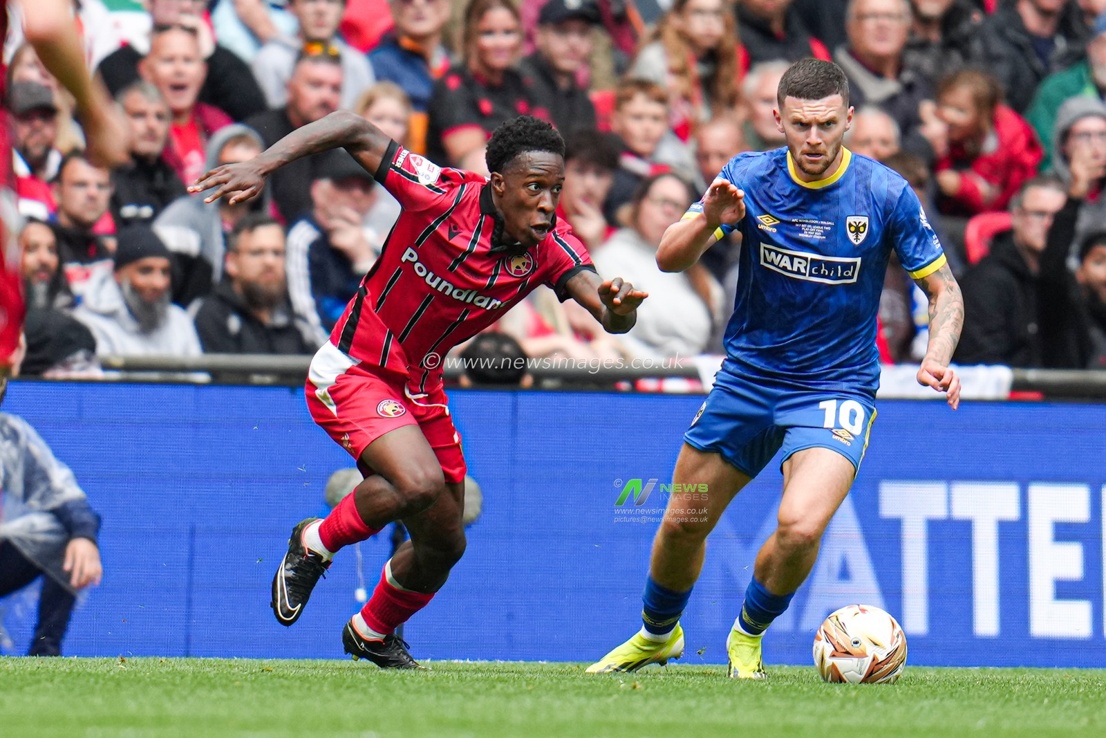 Josh Kelly of AFC Wimbledon on the ball under pressure from Liam Gordon of Walsall during the Sky Bet League 2 Playoff Final match AFC Wimbledon vs Walsall at Wembley Stadium, London, United Kingdom, 26th May 2025

(Photo by Harvey Murphy/News Images)