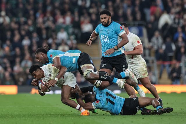 Immanuel Feyi-Waboso of England is tackled by Jiuta Wainiqolo and Vilame Mata of Fiji during the Quilter Nations Series 2025 match England vs Fiji at Allianz Stadium, Twickenham, United Kingdom, 8th November 2025

(Photo by Mark Cosgrove/News Images)

*** GER AUT SUI OUT ***
