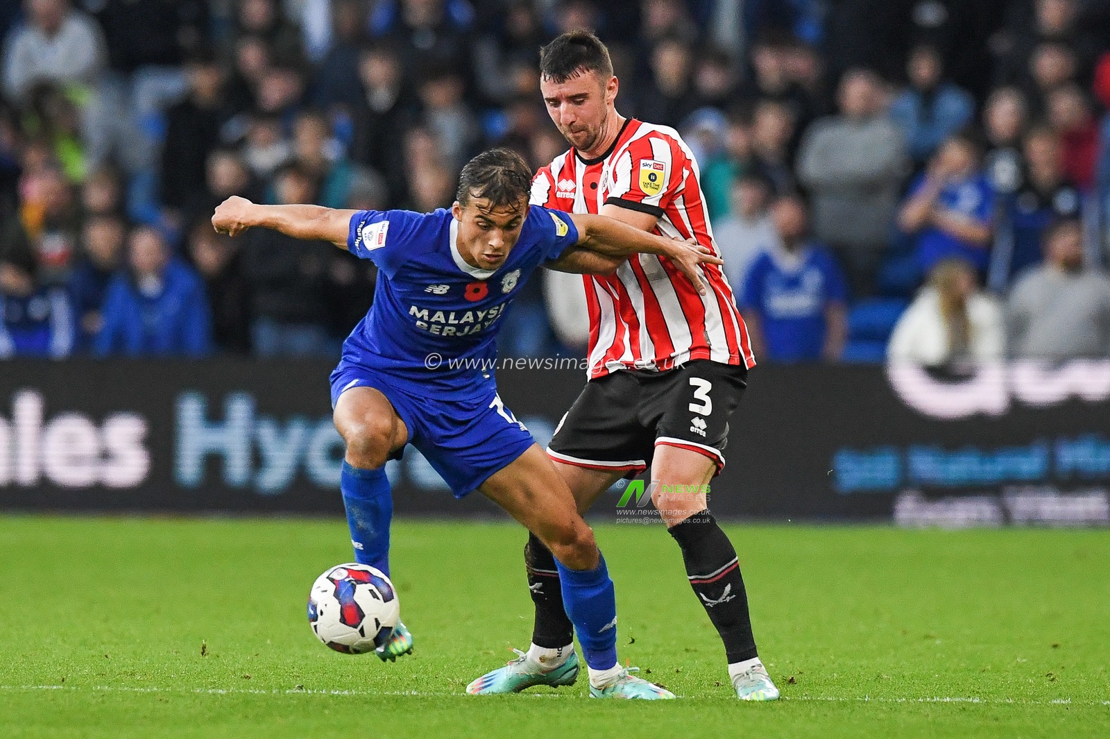 Tom Sang #12 of Cardiff City  Under pressure from Enda Stevens #3 of Sheffield United during the Sky Bet Championship match Cardiff City vs Sheffield United at Cardiff City Stadium, Cardiff, United Kingdom, 12th November 2022

(Photo by Mike Jones/News Images)