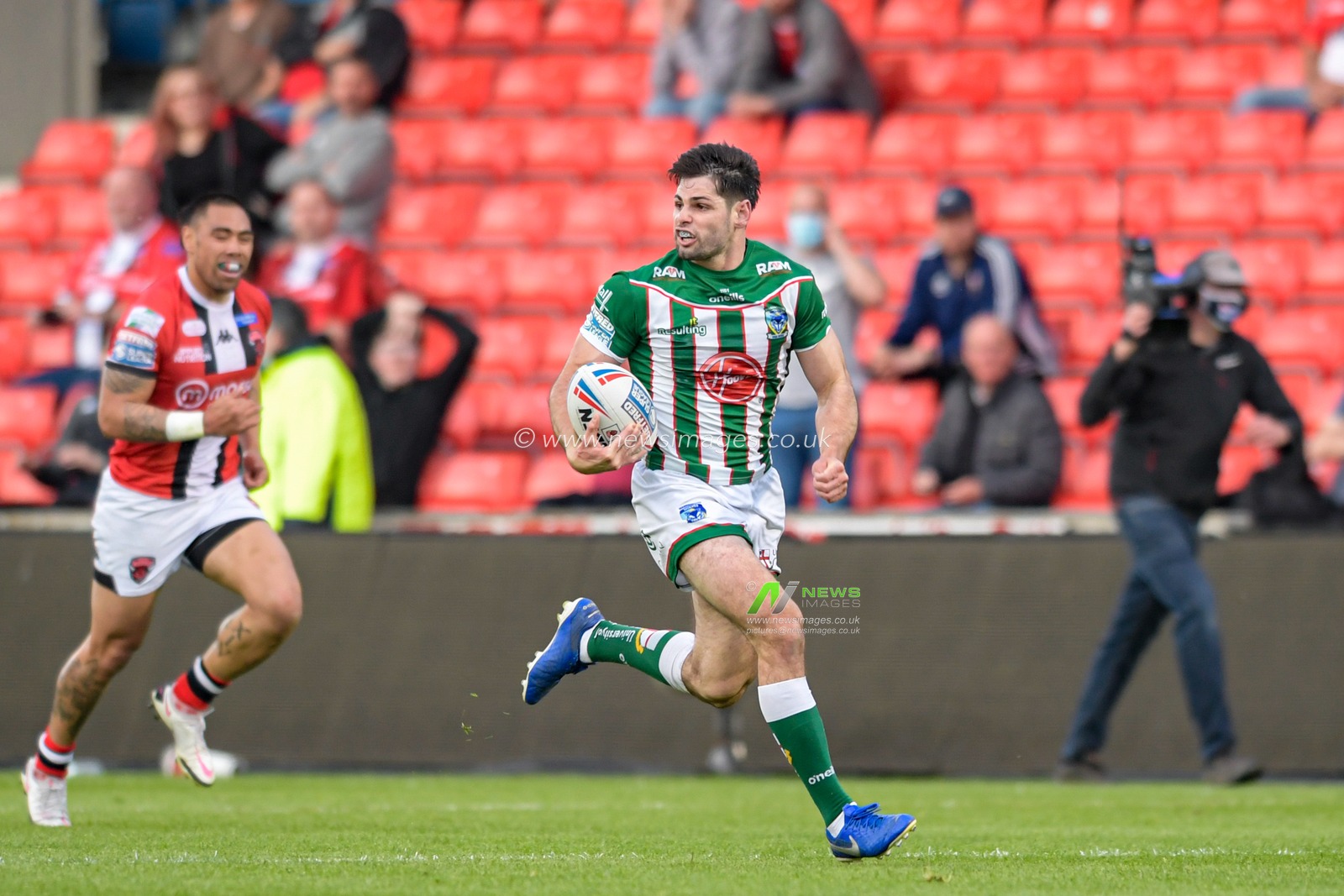 Jake Mamo (18) of Warrington Wolves runs forward with the ball