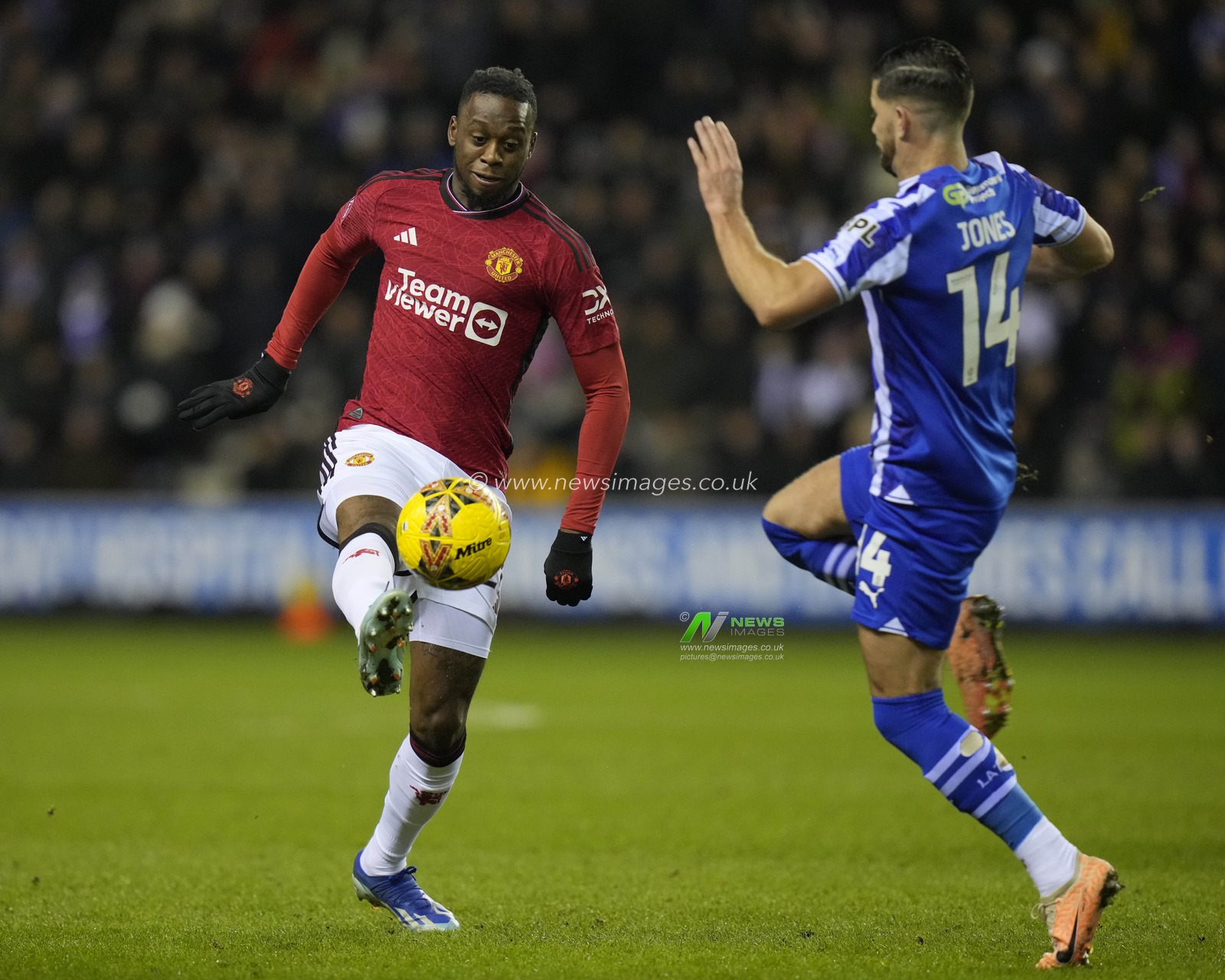 Jordan Jones of Wigan Athletic competes for the ball with Aaron Wan-Bissaka of Manchester United during the Emirates FA Cup Third Round match Wigan Athletic vs Manchester United at DW Stadium, Wigan, United Kingdom, 8th January 2024

(Photo by Steve Flynn/News Images)