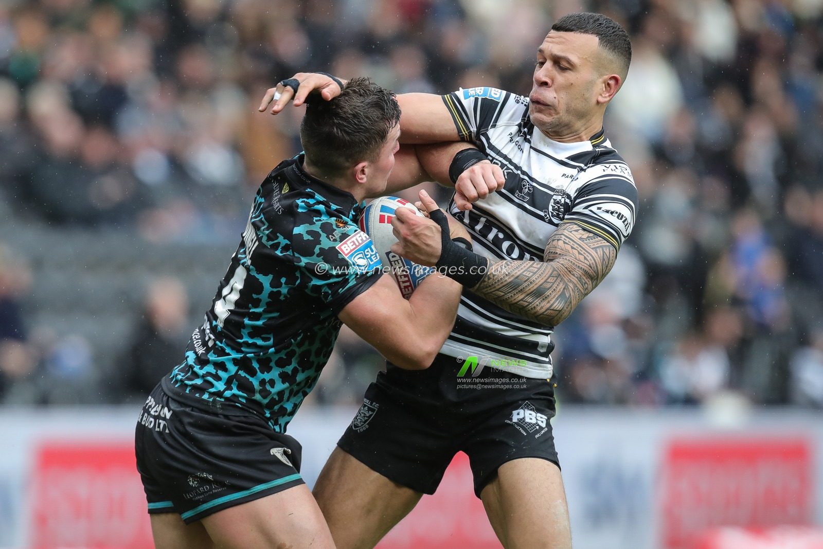 Carlos Tuimavave #3 of Hull FC tackles Kai Oâ€™Donnell #24 of Leigh Leopards during the Betfred Super League  Round 6 match Hull FC vs Leigh Leopards at MKM Stadium, Hull, United Kingdom, 25th March 2023

(Photo by James Heaton/News Images)