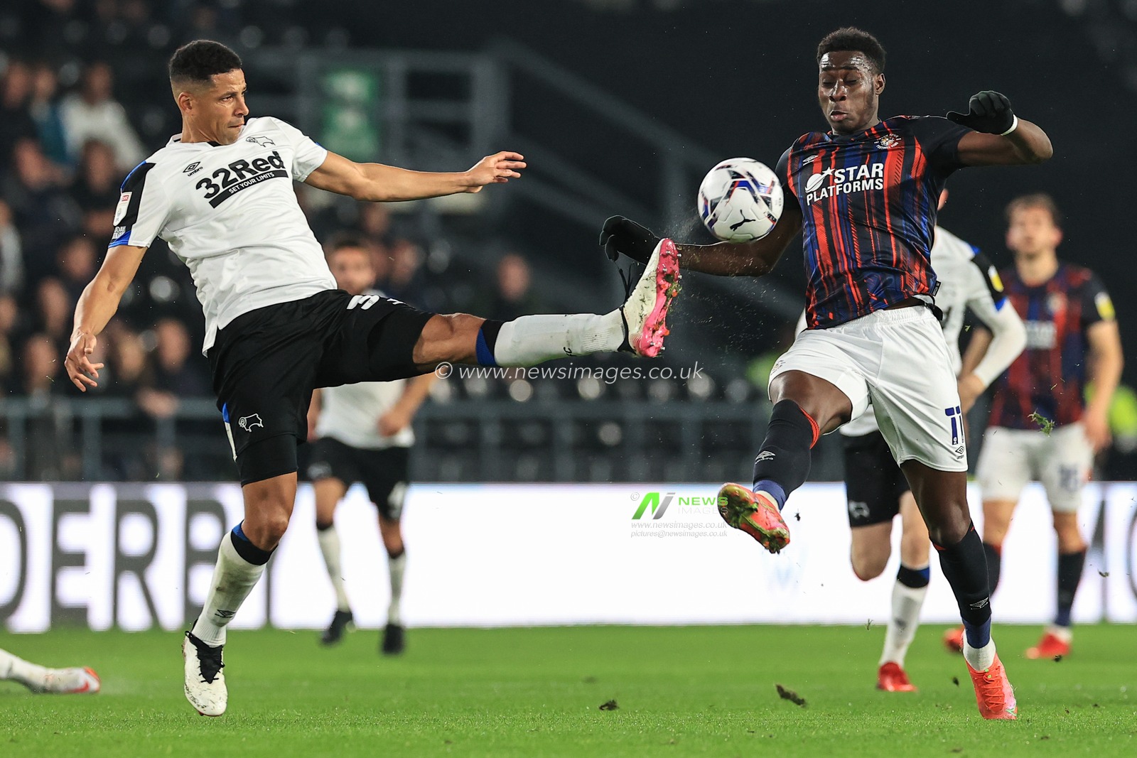 Curtis Davies #33 of Derby County and Elijah Adebayo #11 of Luton Town battle for the ball