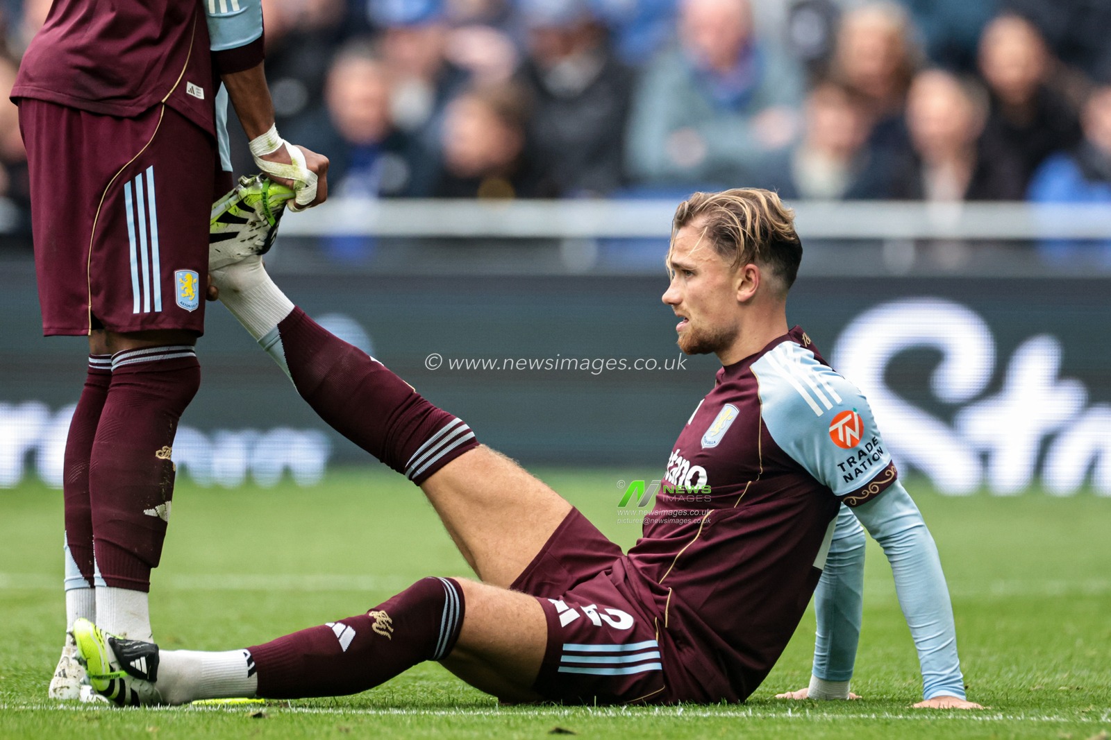 Matty Cash of Aston Villa receives treatment from teammate during the Premier League match Everton vs Aston Villa at Hill Dickinson Stadium, Liverpool, United Kingdom, 13th September 2025

(Photo by Mark Cosgrove/News Images)