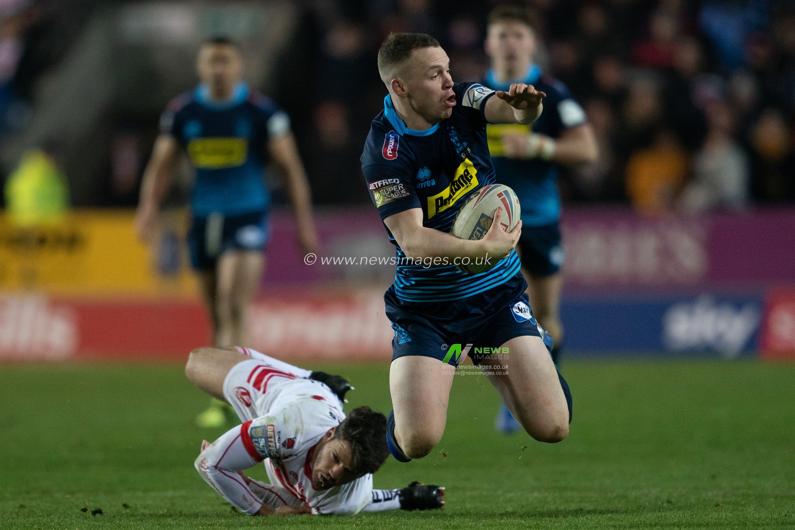 Wigan Warriors's Liam Marshall is tackled by  St. Helens's Lachlan Coote

31st January 2019 , Totally Wicked Stadium, St Helens, England;  Betfred Super League, Round 1, St Helens vs Wigan Warriors 

Credit: Terry Donnelly/News Images