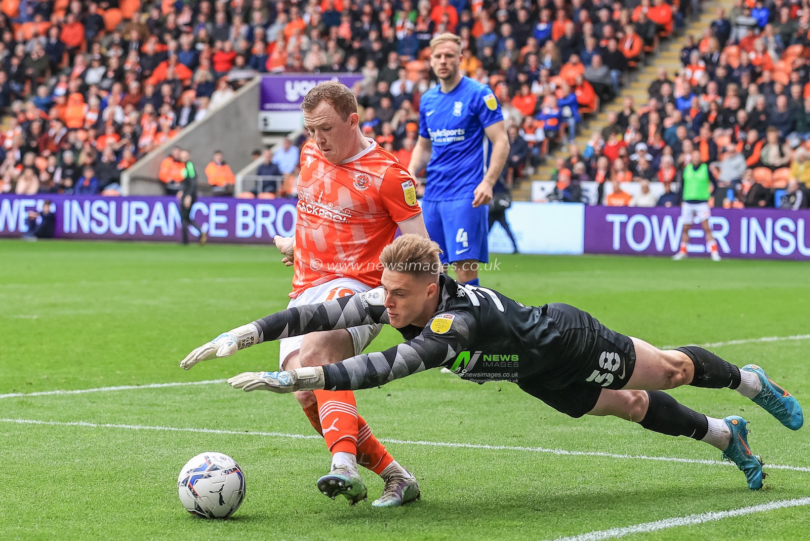 Shayne Lavery #19 of Blackpool flicks the ball away from Zach Jeacock #38 of Birmingham City