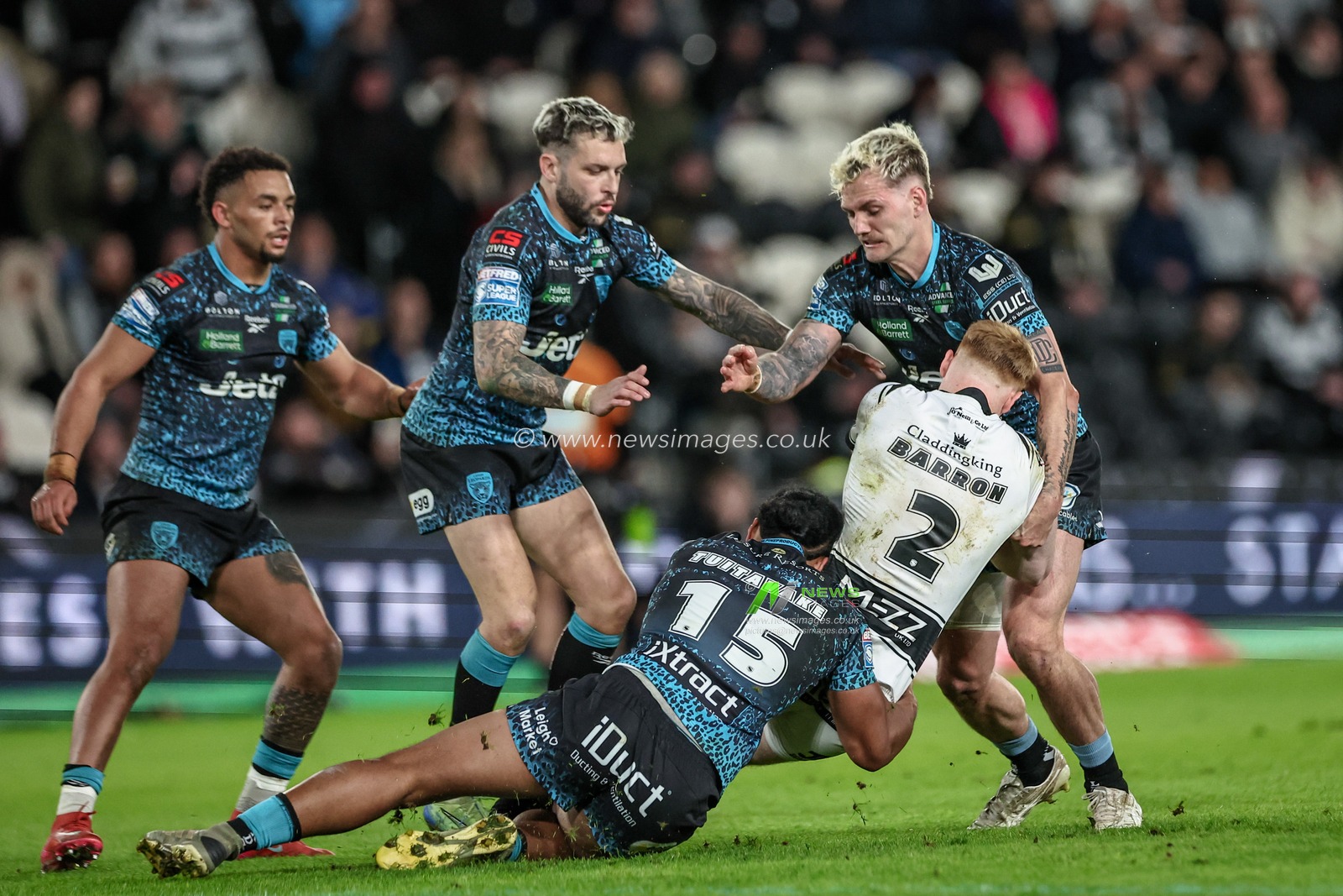 Harvey Barron of Hull FC is tackled by Alec Tuitavake of Leigh Leopards during the Betfred Super League Round 4 match Hull FC vs Leigh Leopards at MKM Stadium, Hull, United Kingdom, 6th March 2025

(Photo by Mark Cosgrove/News Images)