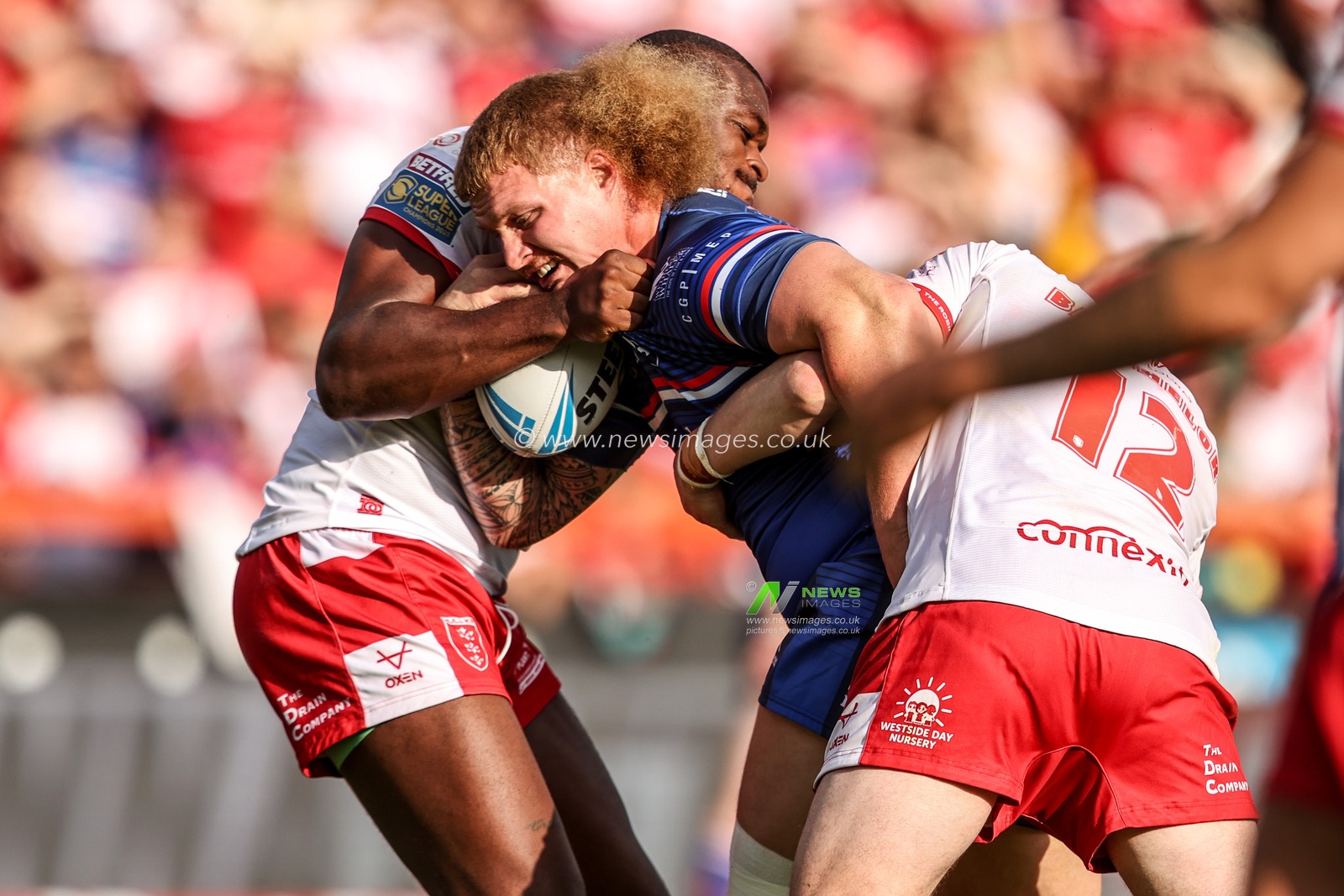 Caius Faatili of Wakefield Trinity is tackled by Jordan Dezaria of Hull KR and James Batchelor of Hull KR during the Betfred Super League round 18 match Hull KR vs Wakefield Trinity at Sewell Group Craven Park, Hull, United Kingdom on 11 July 2026

(Photo by Alfie Cosgrove/News Images)