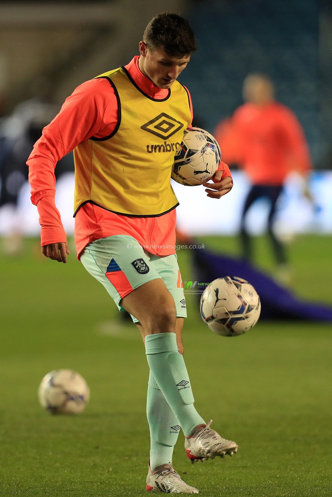 Matty Pearson #4 of Huddersfield Town warms up.