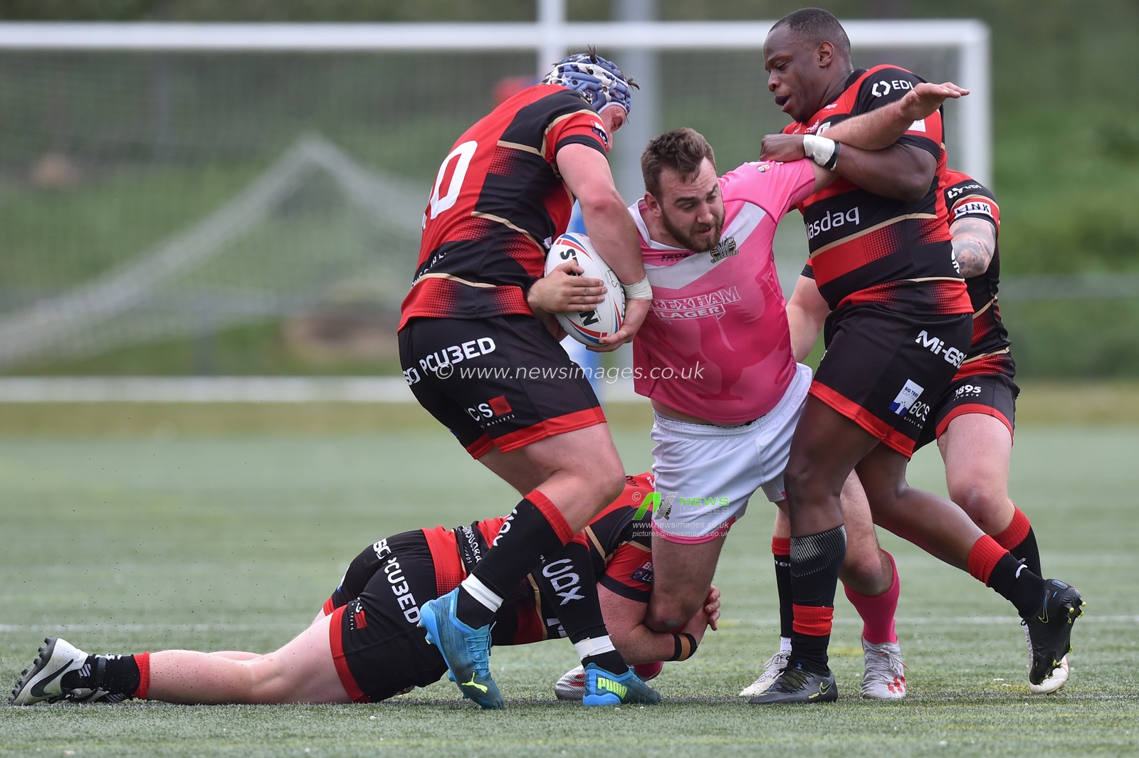 Chris Barratt of North Wales Crusaders is brought down by James Tyas of London Skolars