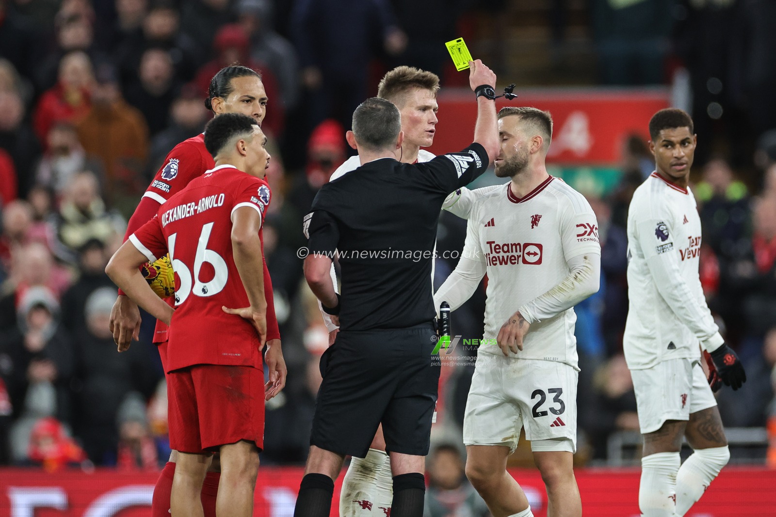 Referee Michael Oliver gives a yellow card to Luke Shaw of Manchester United during the Premier League match Liverpool vs Manchester United at Anfield, Liverpool, United Kingdom, 17th December 2023

(Photo by Mark Cosgrove/News Images)