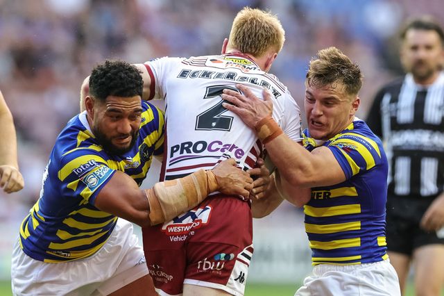 Zach Eckersley of Wigan Warriors is tackled by Kelepi Tanginoa of Warrington Wolves and Leon Hayes of Warrington Wolves during the Betfred Super League round 18 match Wigan Warriors vs Warrington Wolves at The Brick Community Stadium, Wigan, United Kingdom on 10 July 2026

(Photo by Mark Cosgrove/News Images)