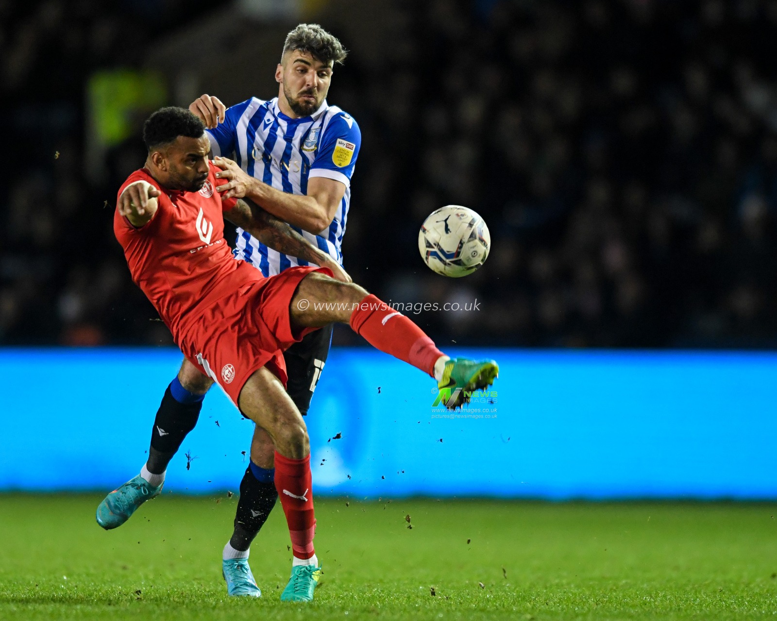 Callum Paterson #13 of Sheffield Wednesday competes for the ball with Curtis Tilt #16 of Wigan Athletic