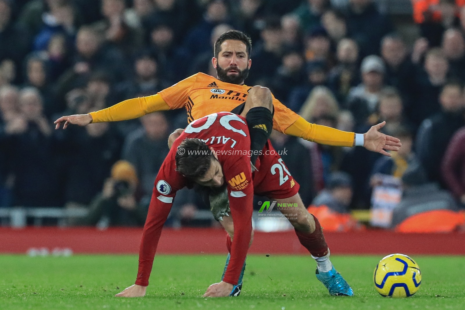 29th December 2019, Anfield, Liverpool, England; Premier League, Liverpool v Wolverhampton Wanderers : JoÃ£o Moutinho (28) of Wolverhampton Wanderers jockeys Adam Lallana (20) of Liverpool as they end up on a heap 

Credit: Mark Cosgrove/News Images