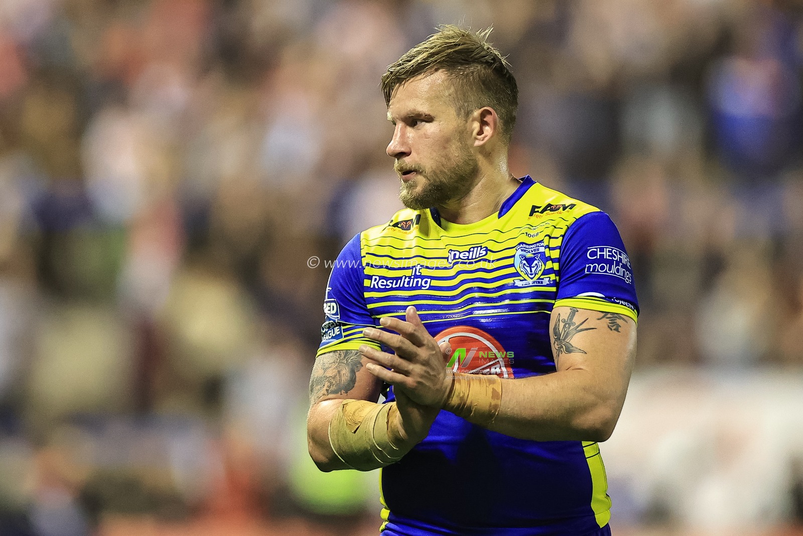 Mike Cooper #10 of Warrington Wolves applauds the fans after the final hooter