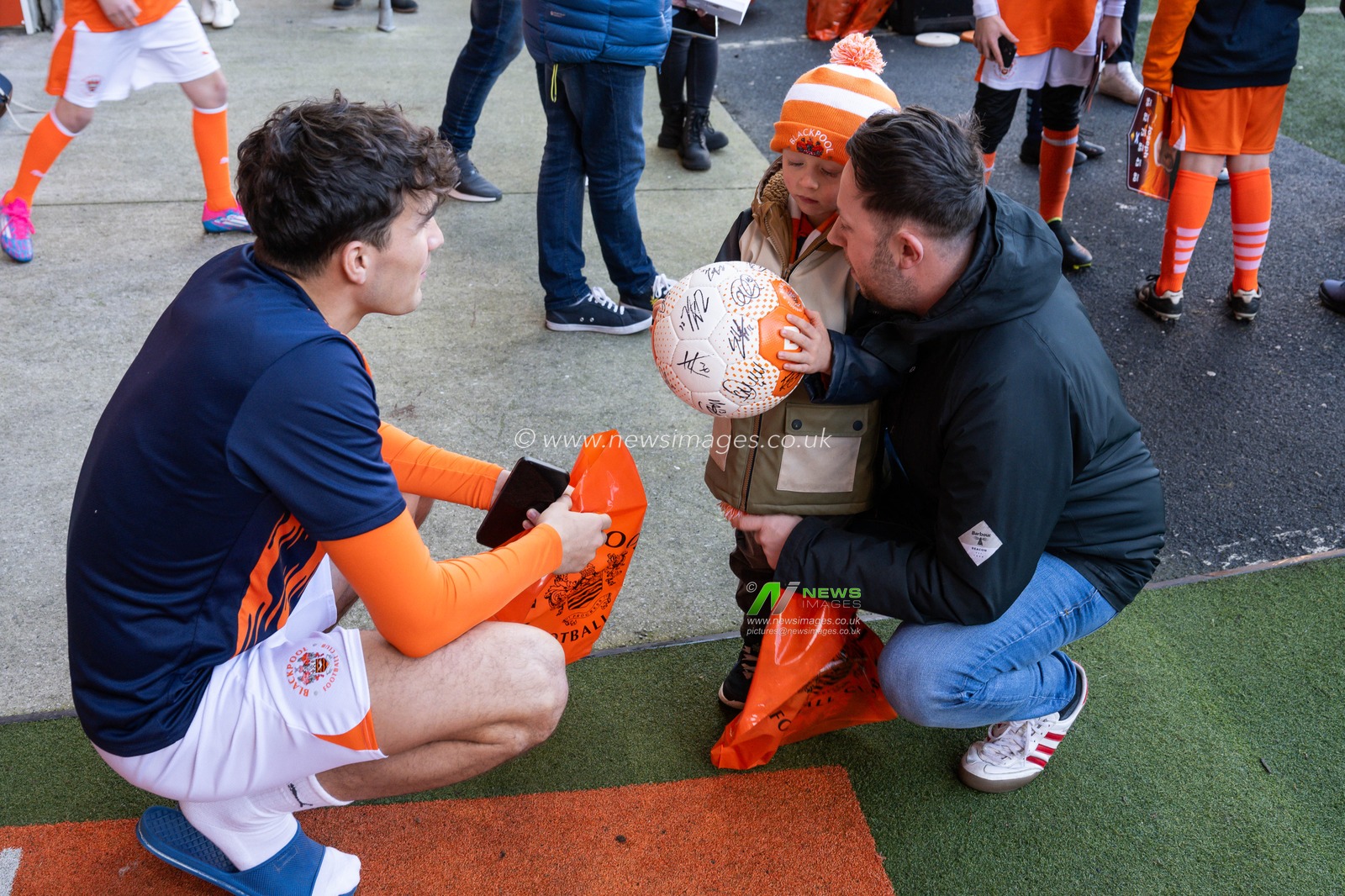 Kyle Joseph of Blackpool presents a young fan with signed match ball during the Sky Bet League 1 match Blackpool vs Shrewsbury Town at Bloomfield Road, Blackpool, United Kingdom, 1st January 2025

(Photo by Craig Thomas/News Images)