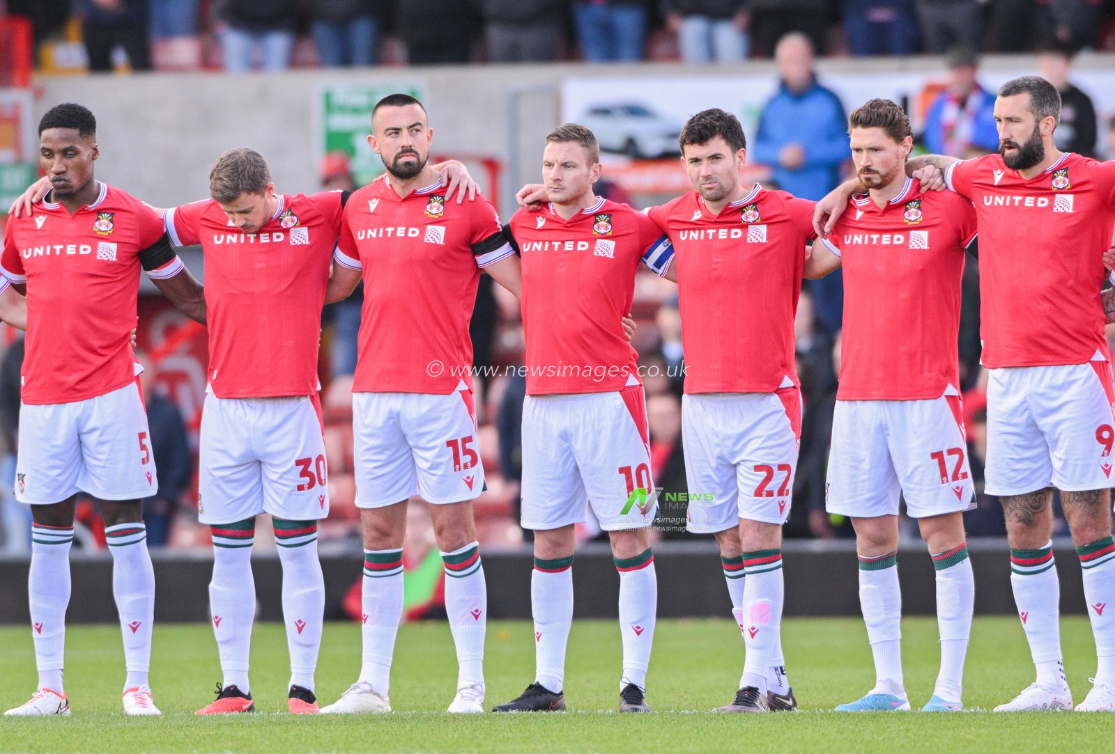 Wrexham squad pause for a minutes silence, during the Sky Bet League 2 match Wrexham vs Salford City at SToK Cae Ras, Wrexham, United Kingdom, 14th October 2023

(Photo by Cody Froggatt/News Images)