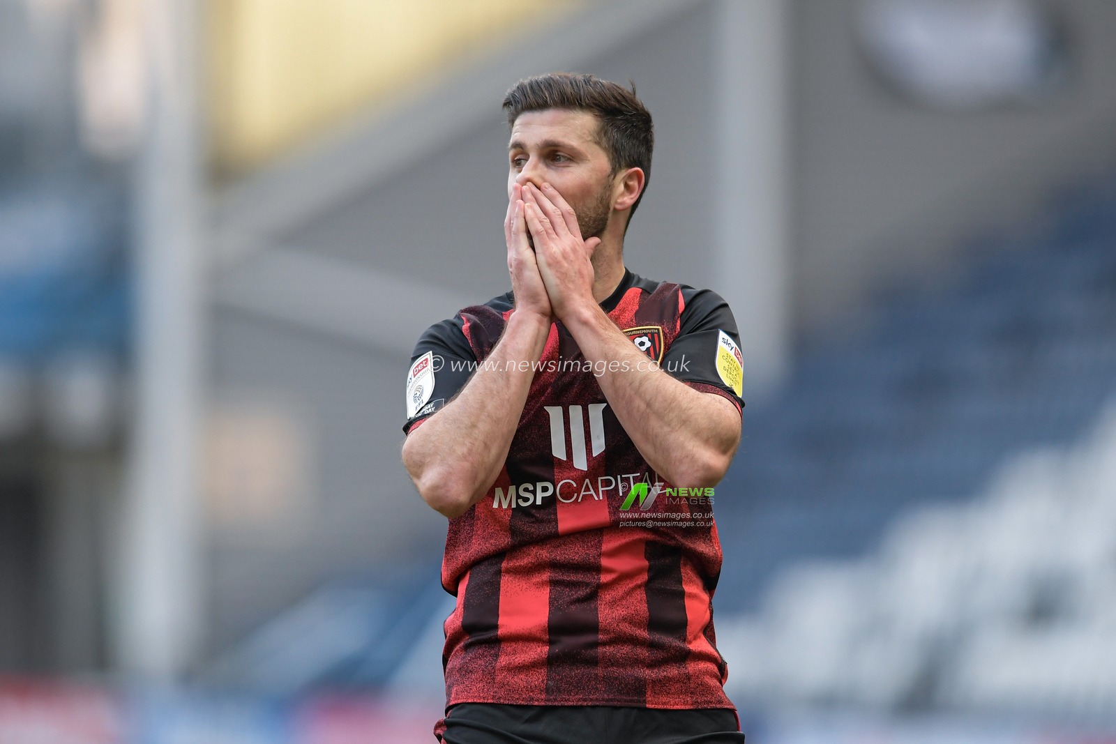 Shane Long #12 of Bournemouth covers his face after delivering a poor cross
