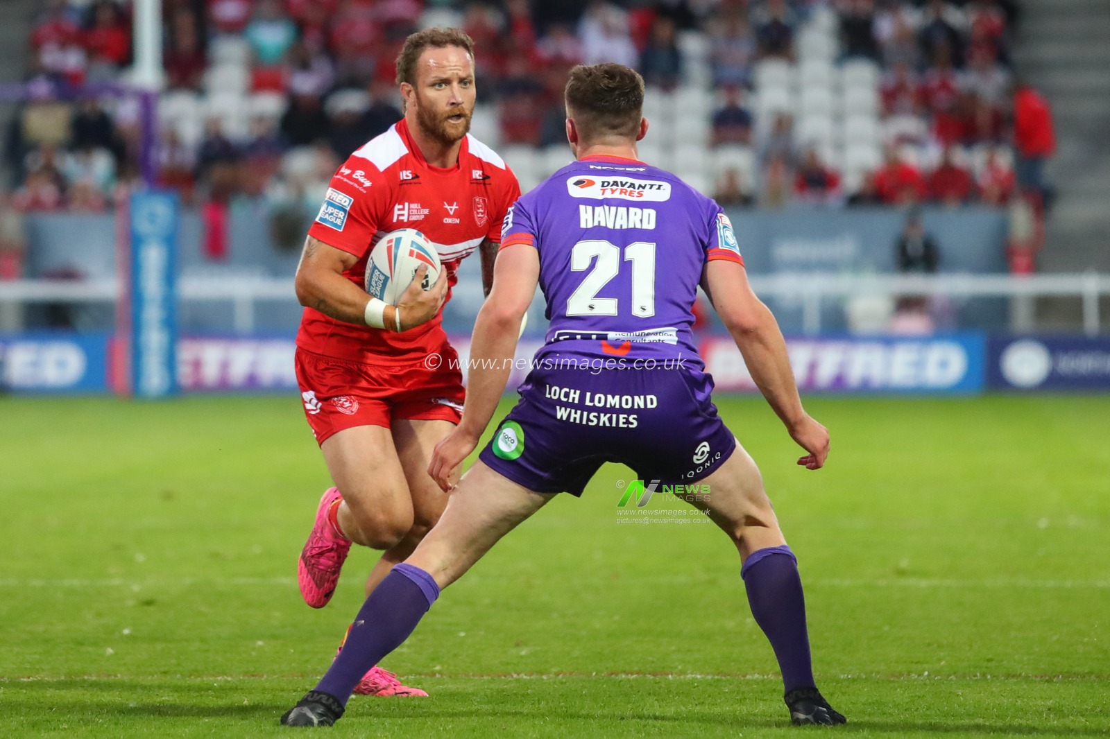 Korbin Sims (10) of Hull KR runs at Ethan Havard (21) of Wigan Warriors