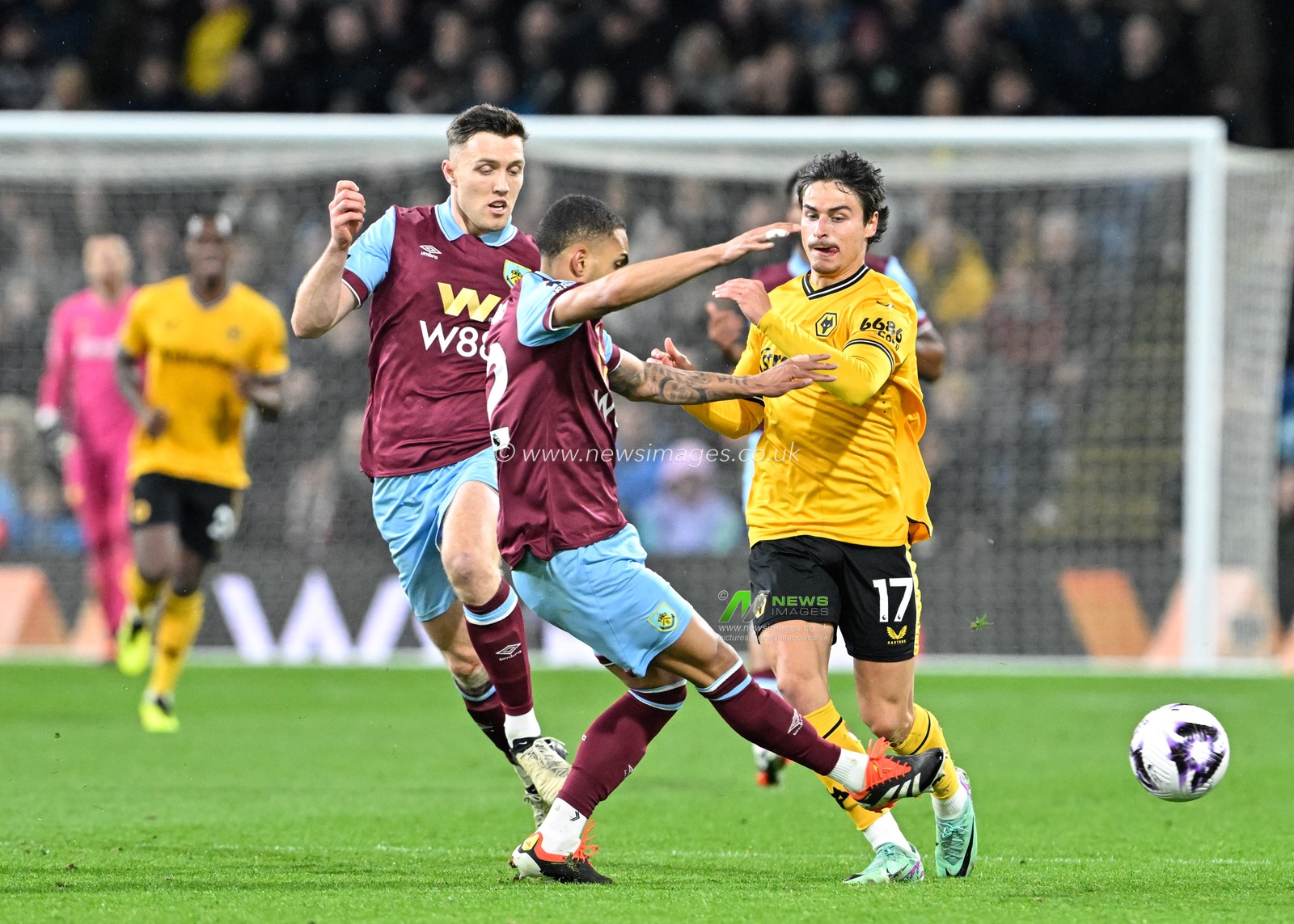 Hugo Bueno of Wolverhampton Wanderers gets tackles by Vitinho of Burnley, during the Premier League match Burnley vs Wolverhampton Wanderers at Turf Moor, Burnley, United Kingdom, 2nd April 2024

(Photo by Cody Froggatt/News Images)