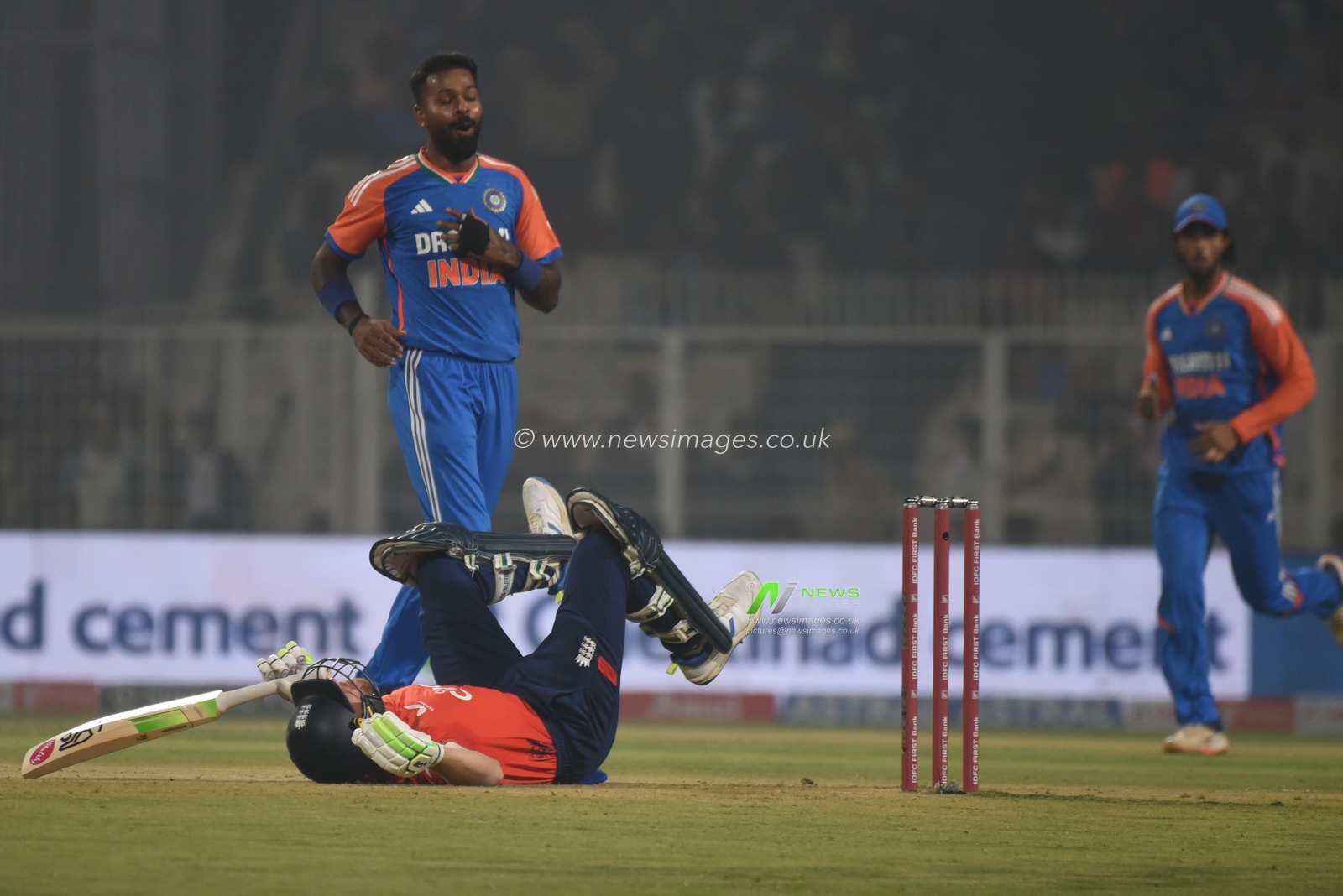 England's captain Jos Buttler falls on the ground in an attempt to play a shot on a delivery by India's Hardik Pandya, left, during the first T20 cricket match between India and England at Eden Gardens in Kolkata, India, Wednesday, Jan. 22, 2025. Pictures by Debajyoti Chakraborty.(Photo: Debajyoti Chakraborty/News Images)