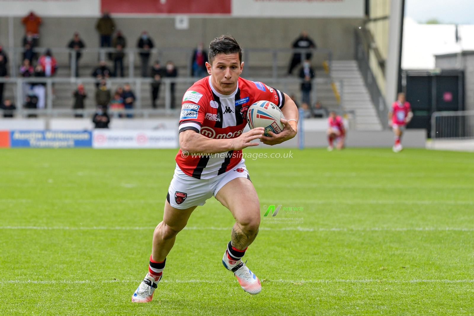 Morgan Escare (1) of Salford Red Devils runs forward with the ball