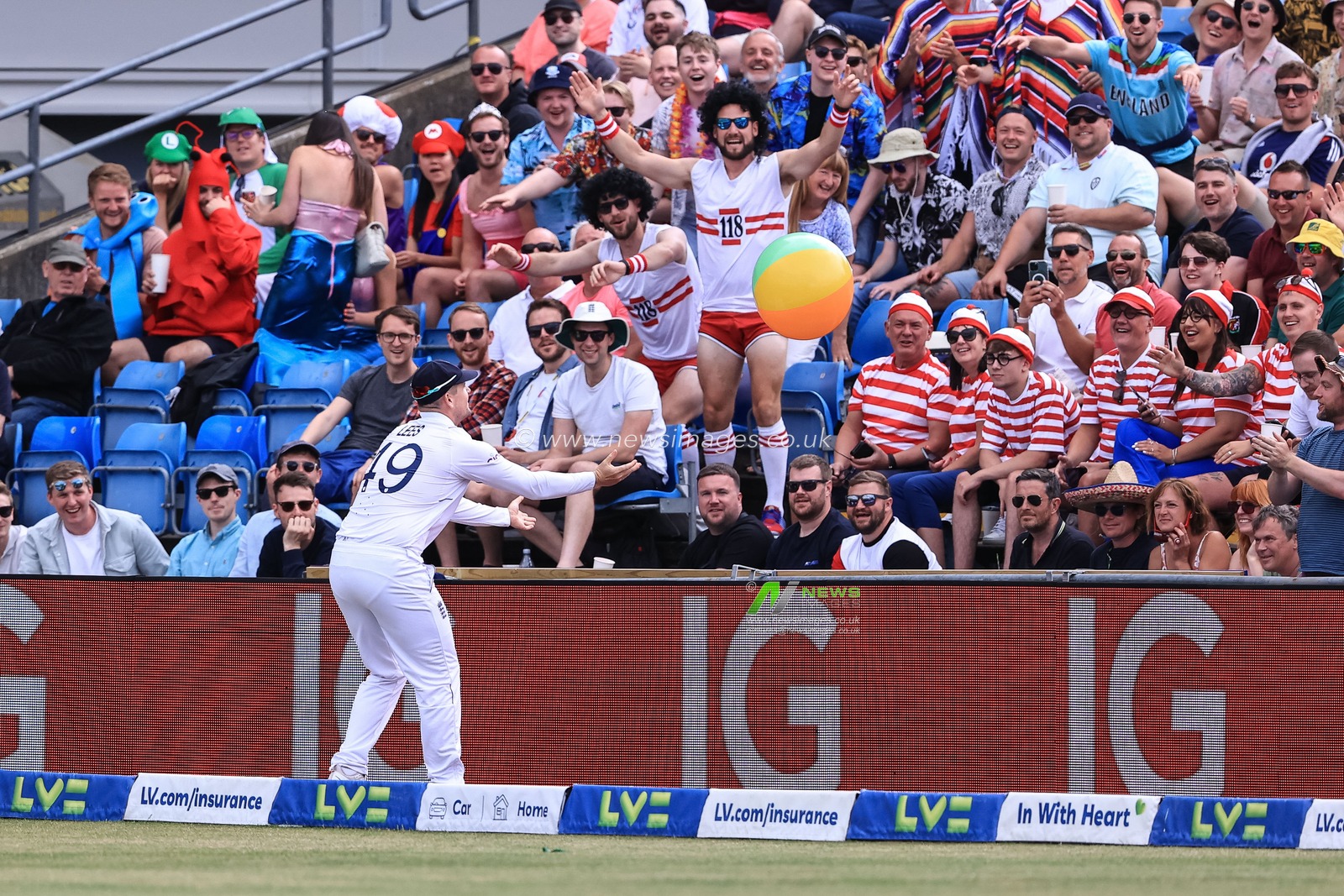Alex Lees of England returns a beach ball back to the fans