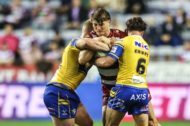Harvey Makin of Wigan Warriors is tackled by James McDonnell of Leeds Rhinos and Brodie Croft of Leeds Rhinos during the Betfred Super League round 27 match Wigan Warriors vs Leeds Rhinos at The Brick Community Stadium, Wigan, United Kingdom, 19th September 2025

(Photo by Alfie Cosgrove/News Images)