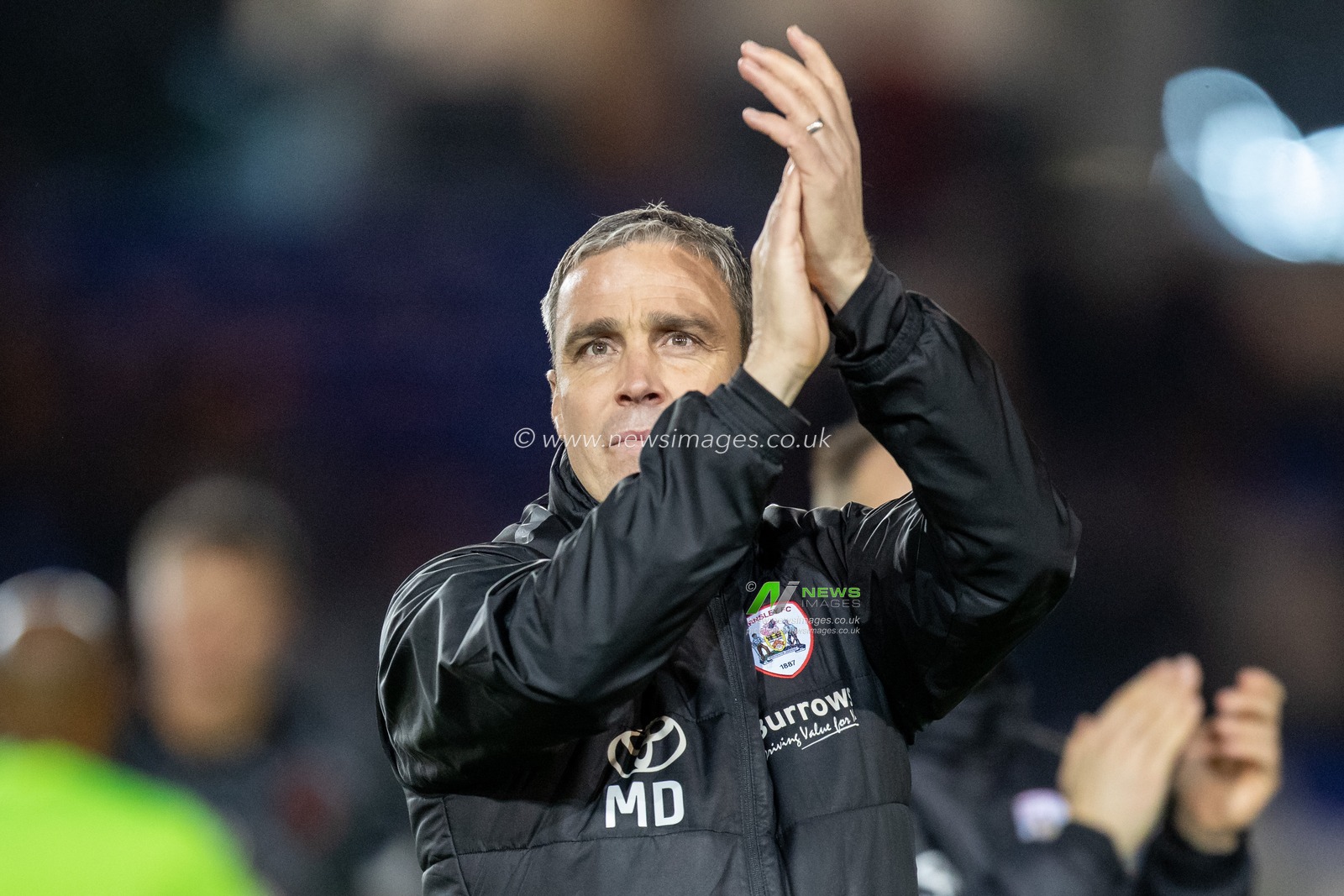 Michael Duff Head coach of Barnsley claps his hands and applauds the supporters at full-time after the Sky Bet League 1 match Peterborough vs Barnsley at Weston Homes Stadium, Peterborough, United Kingdom, 2nd December 2022

(Photo by James Heaton/News Images)