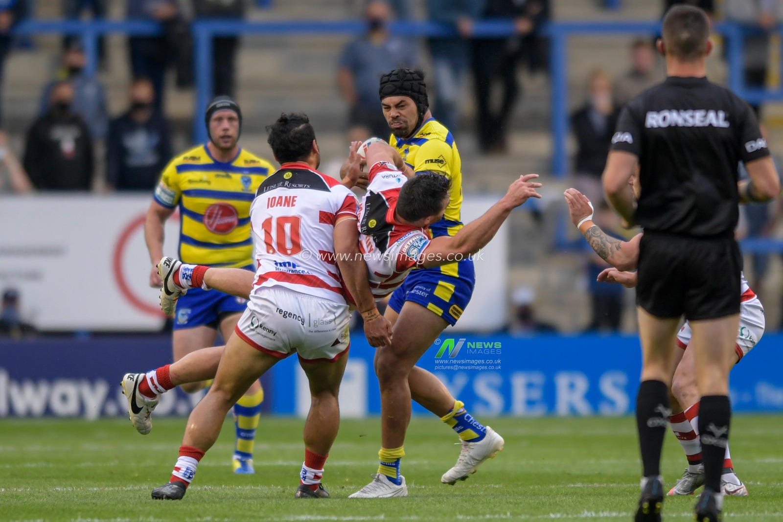 Tyrone McCarthy (21) of Leigh Centurions picks up an injury in his attempt to tackle Sitaleki Akauola (20) of Warrington Wolves