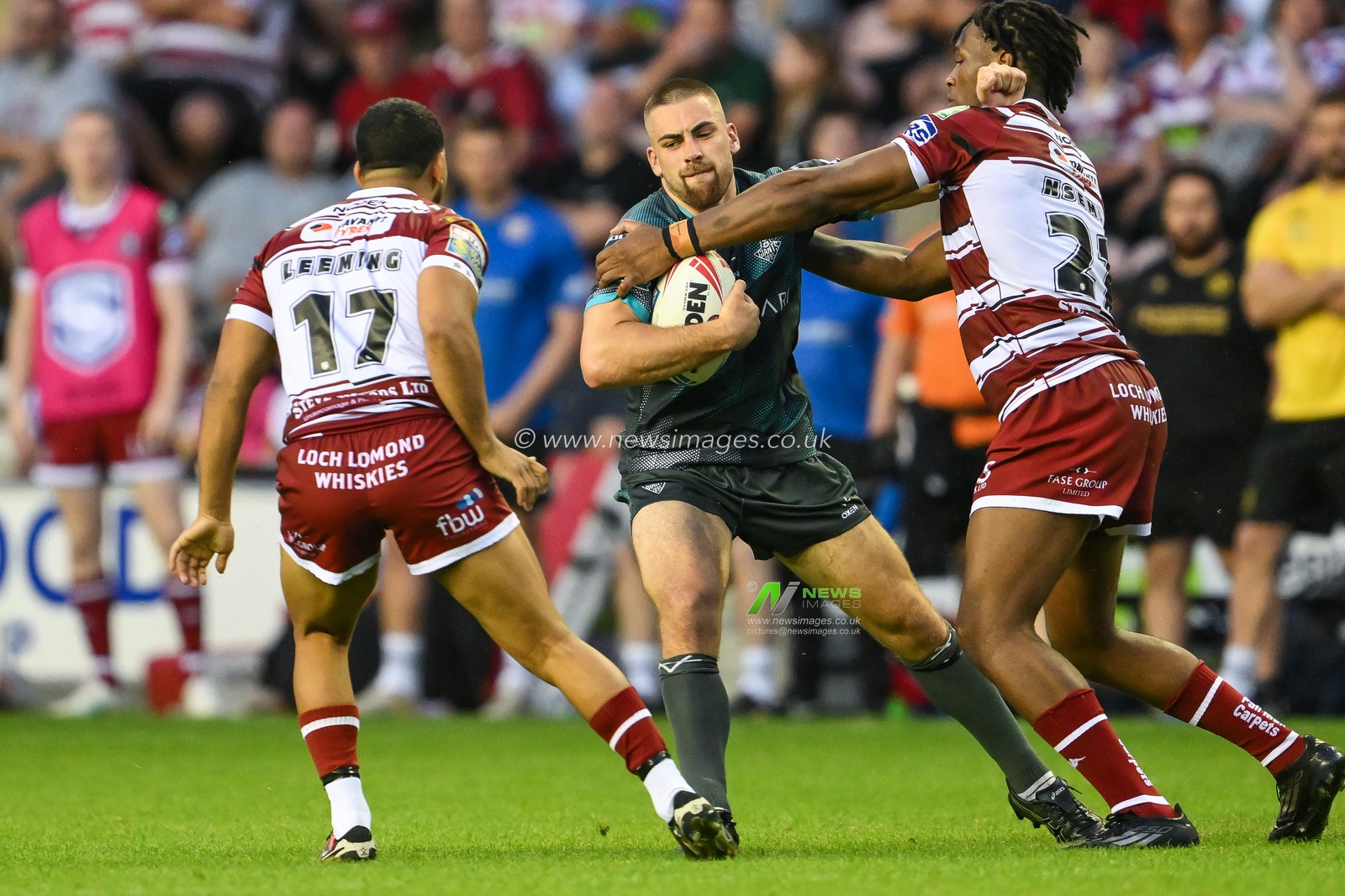 Sam Hewitt of Huddersfield Giants is tackled by Junior Nsemba of Wigan Warriors during the Betfred Super League Round 20 match Wigan Warriors vs Huddersfield Giants at DW Stadium, Wigan, United Kingdom, 1st August 2024

(Photo by Craig Thomas/News Images)