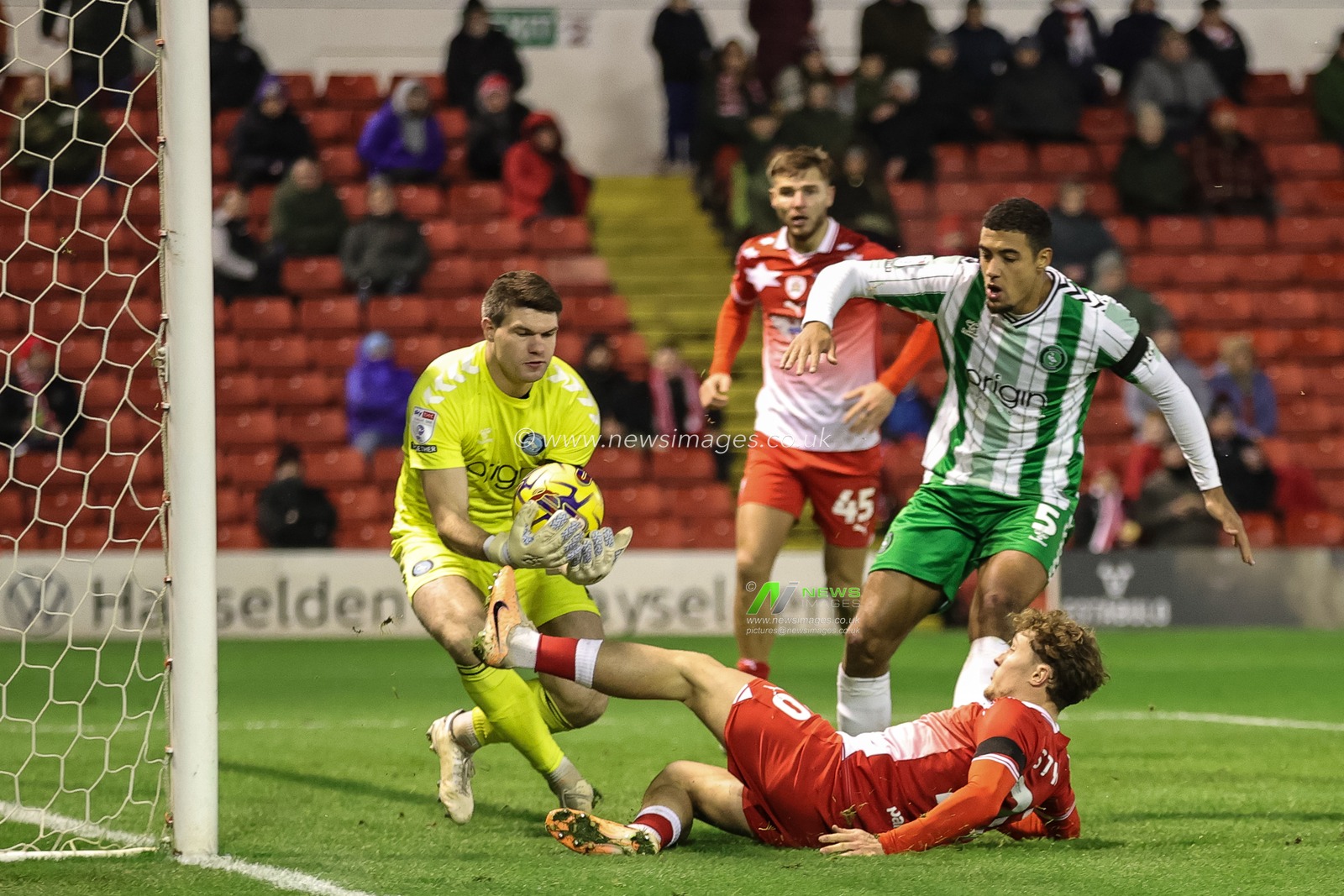 Maksymilian Stryjek #1 of Wycombe Wanderers saves the ball as Callum Styles #20 of Barnsley pressures during the Sky Bet League 1 match Barnsley vs Wycombe Wanderers at Oakwell, Barnsley, United Kingdom, 28th November 2023

(Photo by Mark Cosgrove/News Images)