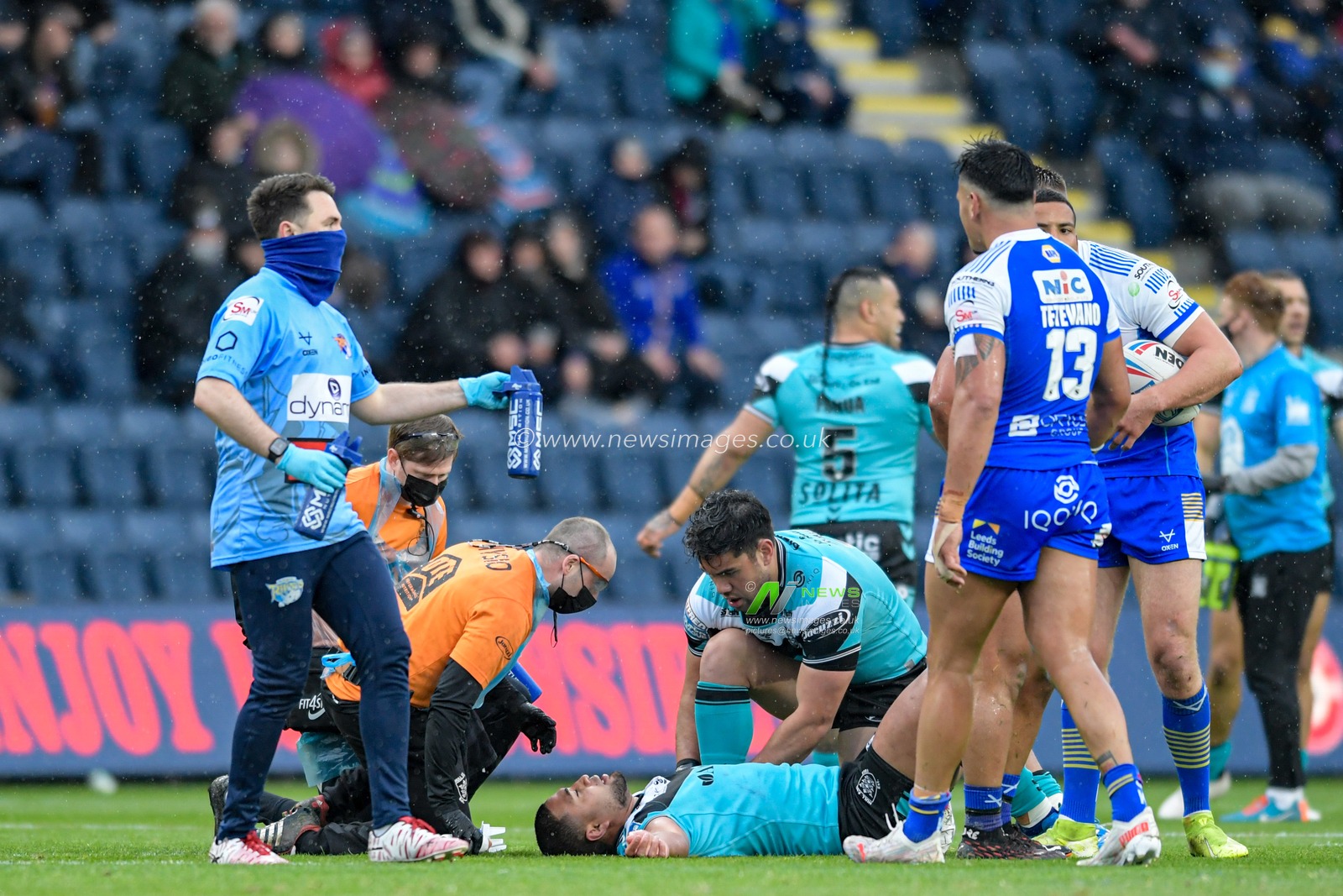 Chris Satae (10) of Hull FC receives treatment on the pitch after an injury