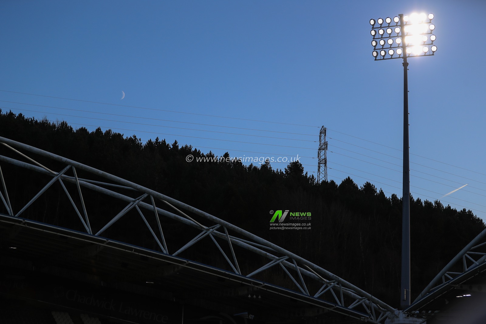The moon rises above The John Smiths Stadium