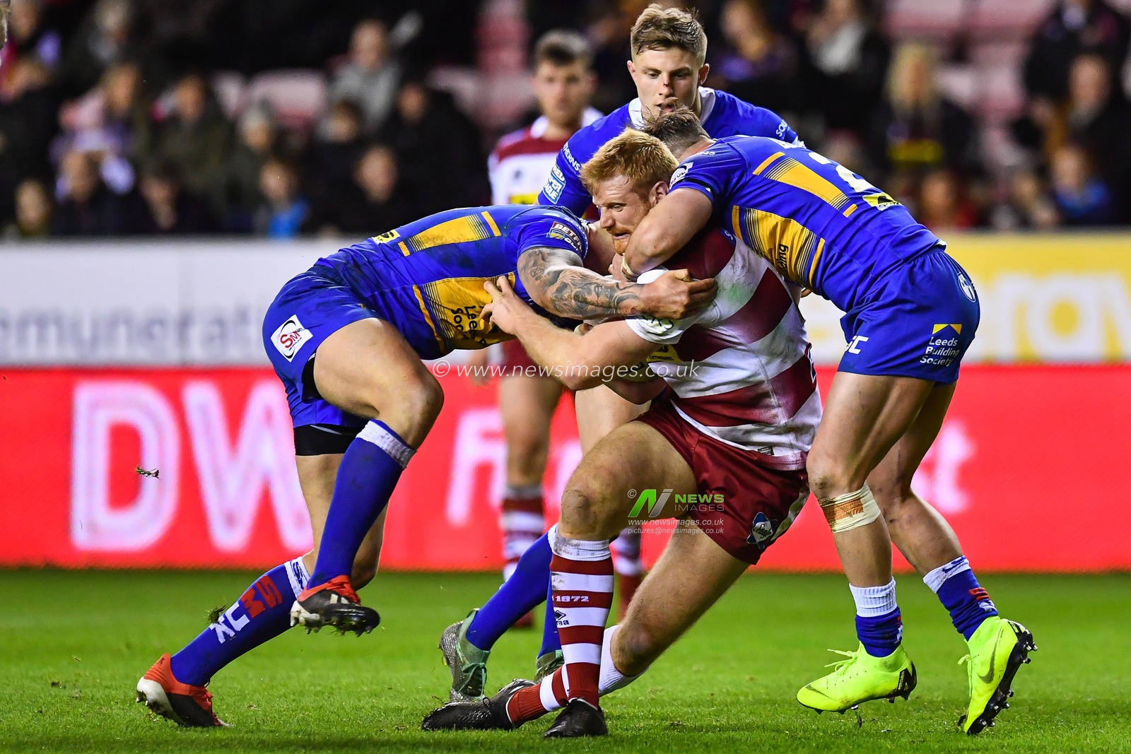 8th February  2019 , DW Stadium, Wigan, England;  Betfred Super League, Round 2, Wigan Warriors vs Leeds Rhinos ; Joe Bullock (22) of Wigan Warriors is tackled by Tom Briscoe (2) of Leeds Rhinos 

Credit: Craig Thomas/News Images