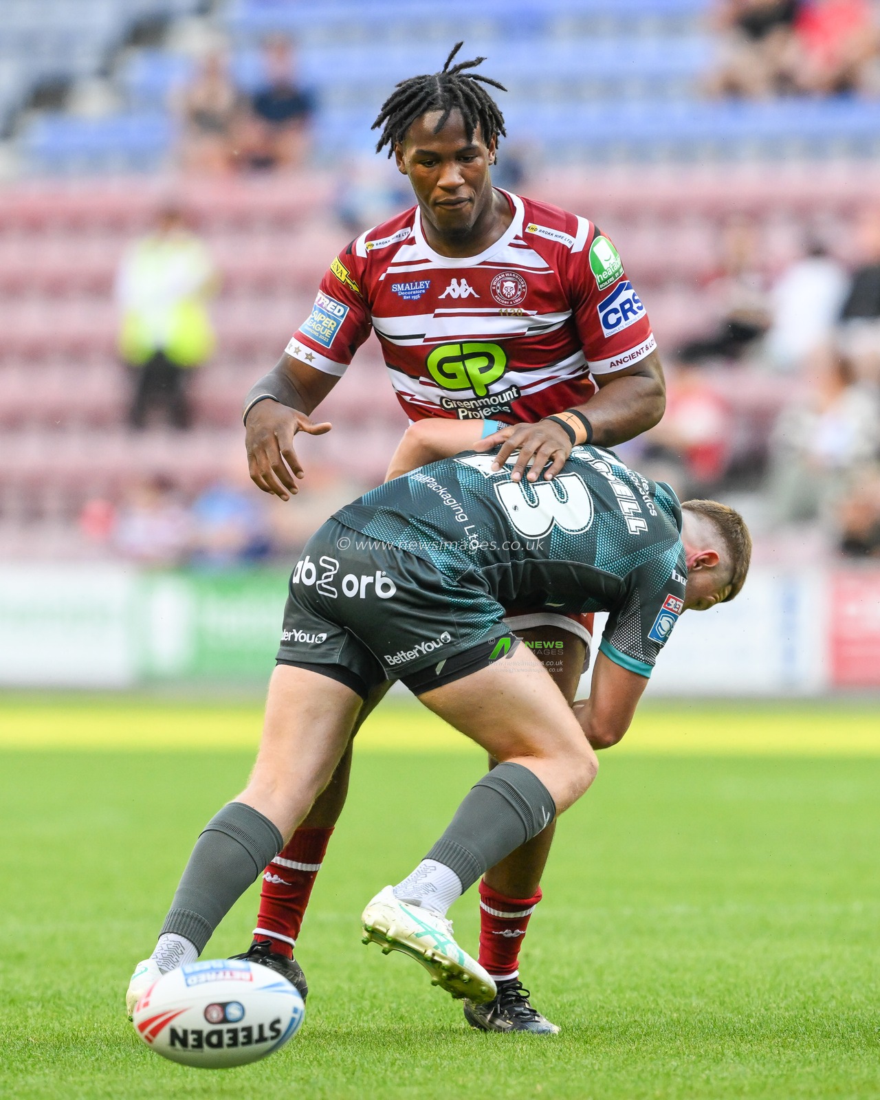 Junior Nsemba of Wigan Warriors spills the ball during the tackle of Olly Russell of Huddersfield Giants during the Betfred Super League Round 20 match Wigan Warriors vs Huddersfield Giants at DW Stadium, Wigan, United Kingdom, 1st August 2024

(Photo by Craig Thomas/News Images)