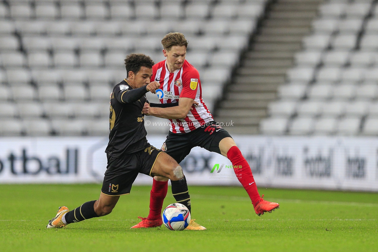 Matthew Sorinola #29 of Milton Keynes Dons battles for possession with Denver Hume #33 of Sunderland