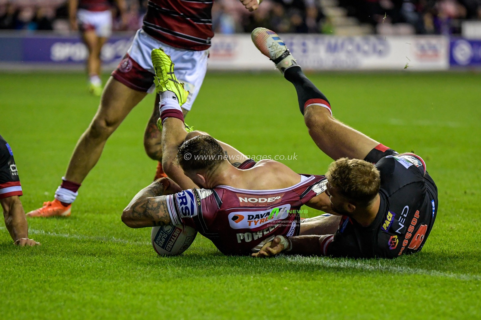 Sam Powell (9) of Wigan Warriors goes over for a try to make it 14-6