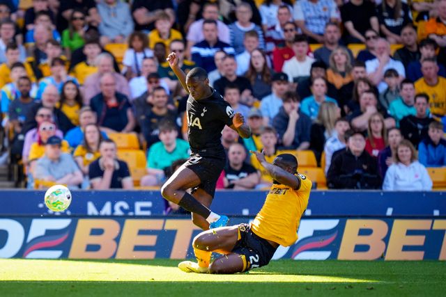 Randal Kolo Muani of Tottenham Hotspur is tackled by  Toti Gomes of Wolverhampton Wanderers during the Premier League match Wolverhampton Wanderers vs Tottenham Hotspur at Molineux, Wolverhampton, United Kingdom on 25 April 2026

(Photo by Maynard Manyowa/News Images)
