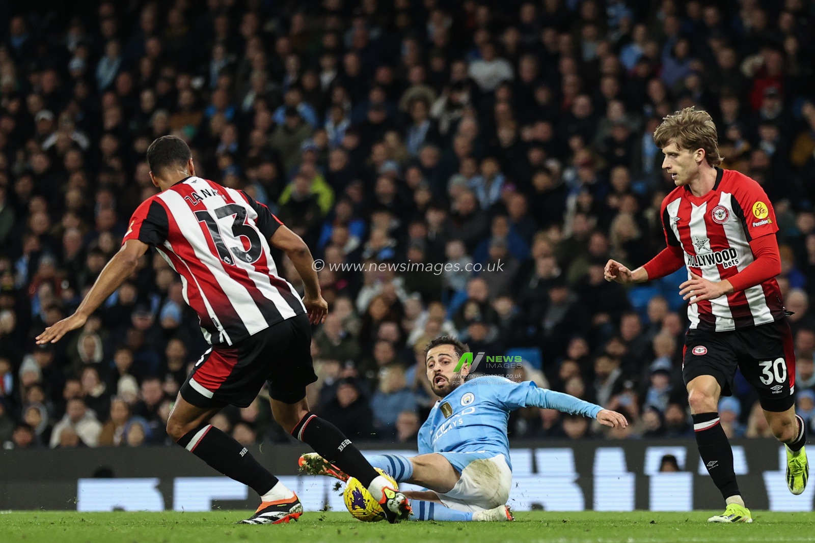 Mathias Zanka JÃ¸rgensen of Brentford tackles Bernardo Silva of Manchester City in the attacking area during the Premier League match Manchester City vs Brentford at Etihad Stadium, Manchester, United Kingdom, 20th February 2024

(Photo by Mark Cosgrove/News Images)