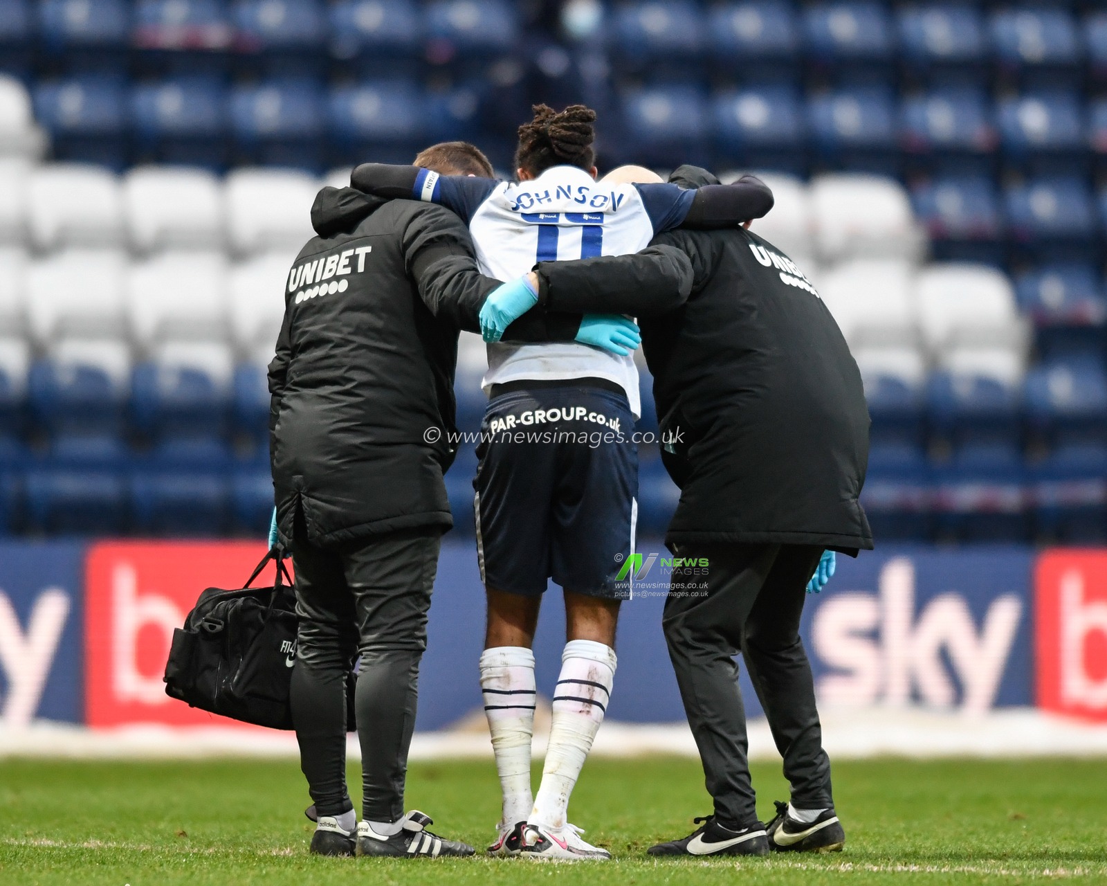 Daniel Johnson #11 of Preston North End is helped from the pitch after picking up an injury